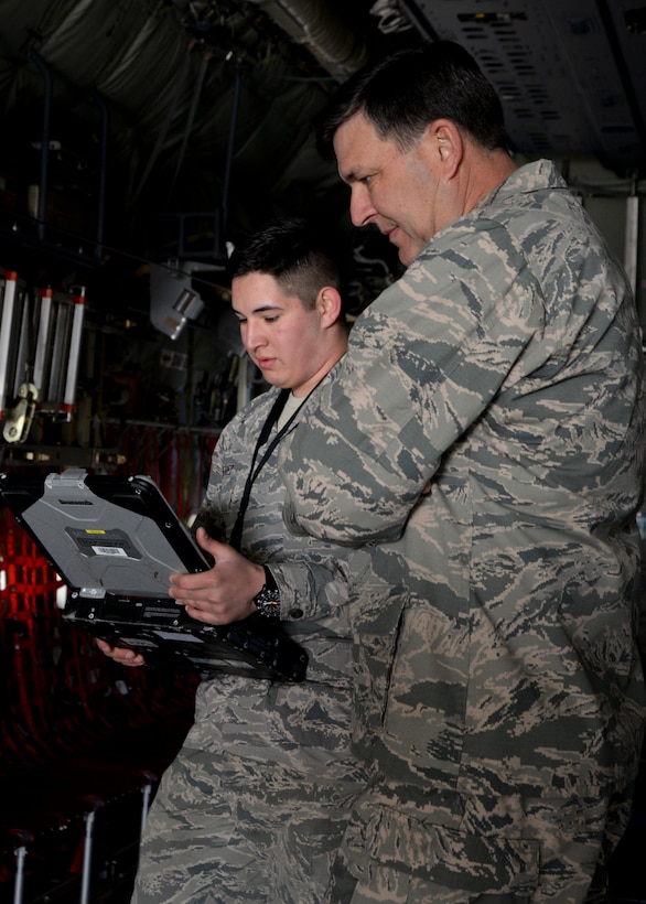 From left, U.S. Air Force Airman Ryan Gutierrez, 352nd Special Operations Maintenance Squadron MC-130J Commando ll aerospace maintenance apprentice, briefs U.S. Air Force Lt. Gen. Brad A.  Heithold, Air Force Special Operations Command commander, on pre-flight inspections during a tour March 23, 2015, on RAF Mildenhall, England. Heithold visited various units to discuss the AFSOC mission and its priorities before the official redesignation ceremony of the 352nd Special Operations Wing.