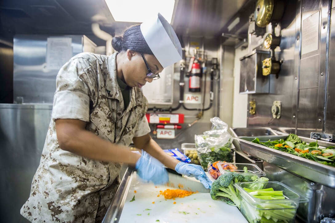 U.S. Marine Lance Cpl. Tayleen Taylor prepares a fresh salad for the officer’s wardroom aboard the USS Rushmore (LSD 47) during Composite Training Unit Exercise (COMPTUEX) off the coast of San Diego March 22, 2015. Taylor is a food service specialist with Combat Logistics Battalion 15, 15th Marine Expeditionary Unit. The food service specialist Marines work long hours to ensure the Marines or Sailors are fed daily. (U.S. Marine Corps photo by Sgt. Emmanuel Ramos/Released)