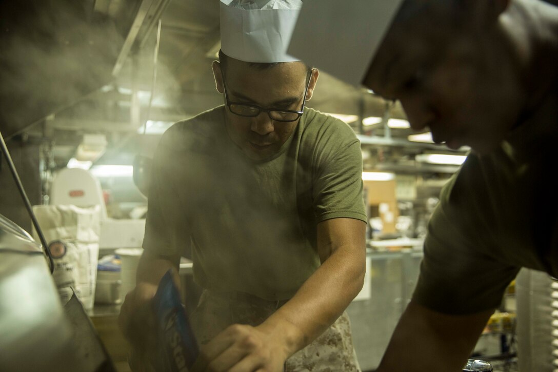 U.S. Marine Cpl. George Gacilo prepares a tuna fish casserole for more than 700 Marines and Sailors aboard the USS Rushmore (LSD 47) during Composite Training Unit Exercise (COMPTUEX) off the coast of San Diego March 22, 2015. Gacilo is a food service specialist with Combat Logistics Battalion 15, 15th Marine Expeditionary Unit. Prior to being a food service specialist, Gacilo was a motor transportation operator, but changed his military occupational specialty to follow in his grandfather’s footsteps who was a cook in the U.S. Air Force. The food service specialist Marines work long hours to ensure the Marines and Sailors are fed daily. (U.S. Marine Corps photo by Sgt. Emmanuel Ramos/Released)