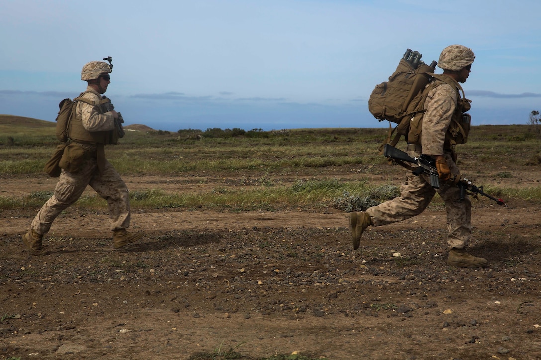 U.S. Marines with Lima Company, Battalion Landing Team 3rd Battalion, 1st Marine Regiment, 15th Marine Expeditionary Unit, run toward their objective during Composite Training Unit Exercise (COMPTUEX) on San Clemente Island, Calif., March 22, 2015. As part of the 15th MEU’s ground combat element, the Marines practiced their urban movement and room clearing skills in preparation for their deployment. (U.S. Marine Corps photo by Cpl. Anna Albrecht/Released)