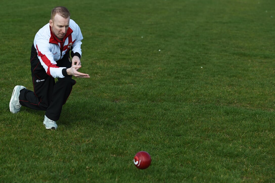 Nick Brett rolls a ball, called a “bowl,” down the athletic field March 23, 2015, at Royal Air Force Alconbury, England. Currently, Brett is ranked as the number bowler in the world. Brett is the water and fuels shop chief for the 423rd Civil Engineer Squadron. (U.S. Air Force photo/Staff Sgt. Jarad A. Denton)