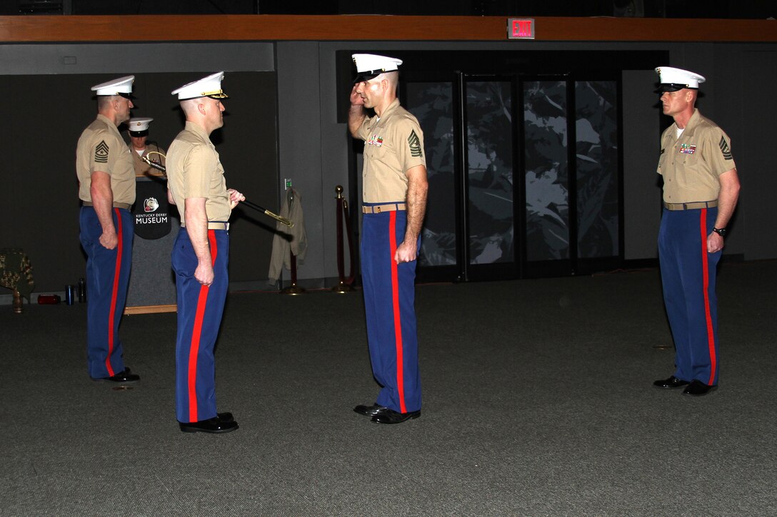 U.S. Marine Corps Sgt. Maj. John K. Wyatt, center right, incoming sergeant major of Marine Corps Recruiting Station Louisville, Kentucky, salutes U.S. Marine Corps Maj. Donald Hotchkiss, commanding officer of RS Louisville, before being handed the noncommissioned officers sword during an appointment, relief and retirement ceremony at the Kentucky Derby Museum, March 20, 2015.  The passing of the sword symbolizes the responsibility of the welfare of all Marines appointed under him. Wyatt reported for duty at RS Louisville after completing a tour as the Drill Instructor School First  Sergeant at Marine Corps Recruit Depot Parris Island, South Carolina. Wyatt replaced U.S. Marine Corps Sgt. Maj. Daniel G. Bullock who retired after 27 years of service. (Courtesy photo by Rachel Rosenblatt/Released)