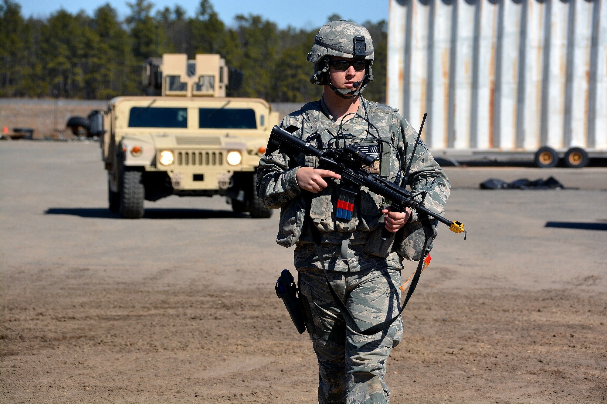 Airman 1st Class Andrew Denman patrols a campsite following a mock attack from opposing forces, March 12, 2015, during Exercise Eagle Flag 15-2, at Joint Base McGuire-Dix-Lakehurst, New Jersey. Eagle Flag is a U.S. Air Force Expeditionary Center exercise used to execute and evaluate mobility operations and expeditionary combat support. Denman is assigned to the 570th Global Mobility Readiness Squadron. (U.S. Air Force photo/Senior Airman Charles Rivezzo)