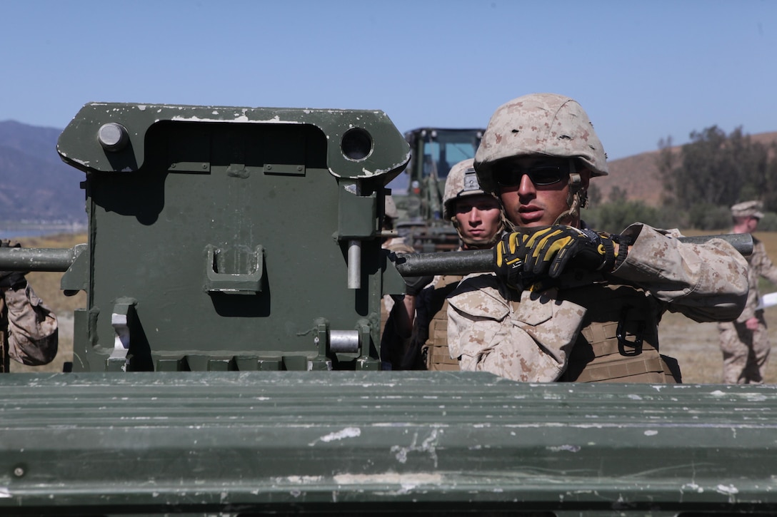 Marines from Bridge Company, 7th Engineer Support Battalion, 1st Marine Logistics Group, conduct a bridge exercise at Lake Elsinore, Calif., March 24, 2015. Marines built an improved ribbon bridge and a medium girder bridge. This event marks the first time a continuous span bridge from shore to shore has been built since 2002.
