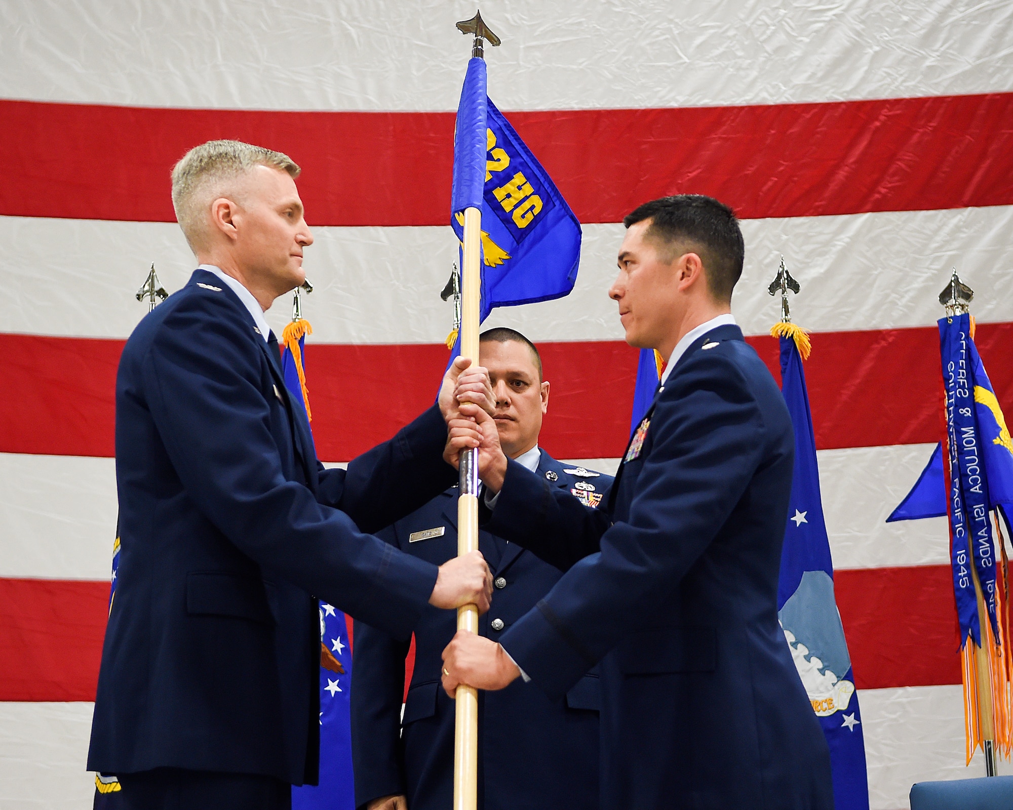 Col. Dave Smith, 582nd Helicopter Group commander, hands the guidon of the newly established 582nd Operations Support Squadron to Lt. Col. James Blanchard during the squadron’s assumption of command ceremony March 27, 2015, on F.E. Warren Air Force Base, Wyo. Detachments from the 582nd OSS will be established at the three missile bases under 20th to provide maintenance and support for the groups’ squadrons. (U.S. Air Force photo by R.J. Oriez/Released)