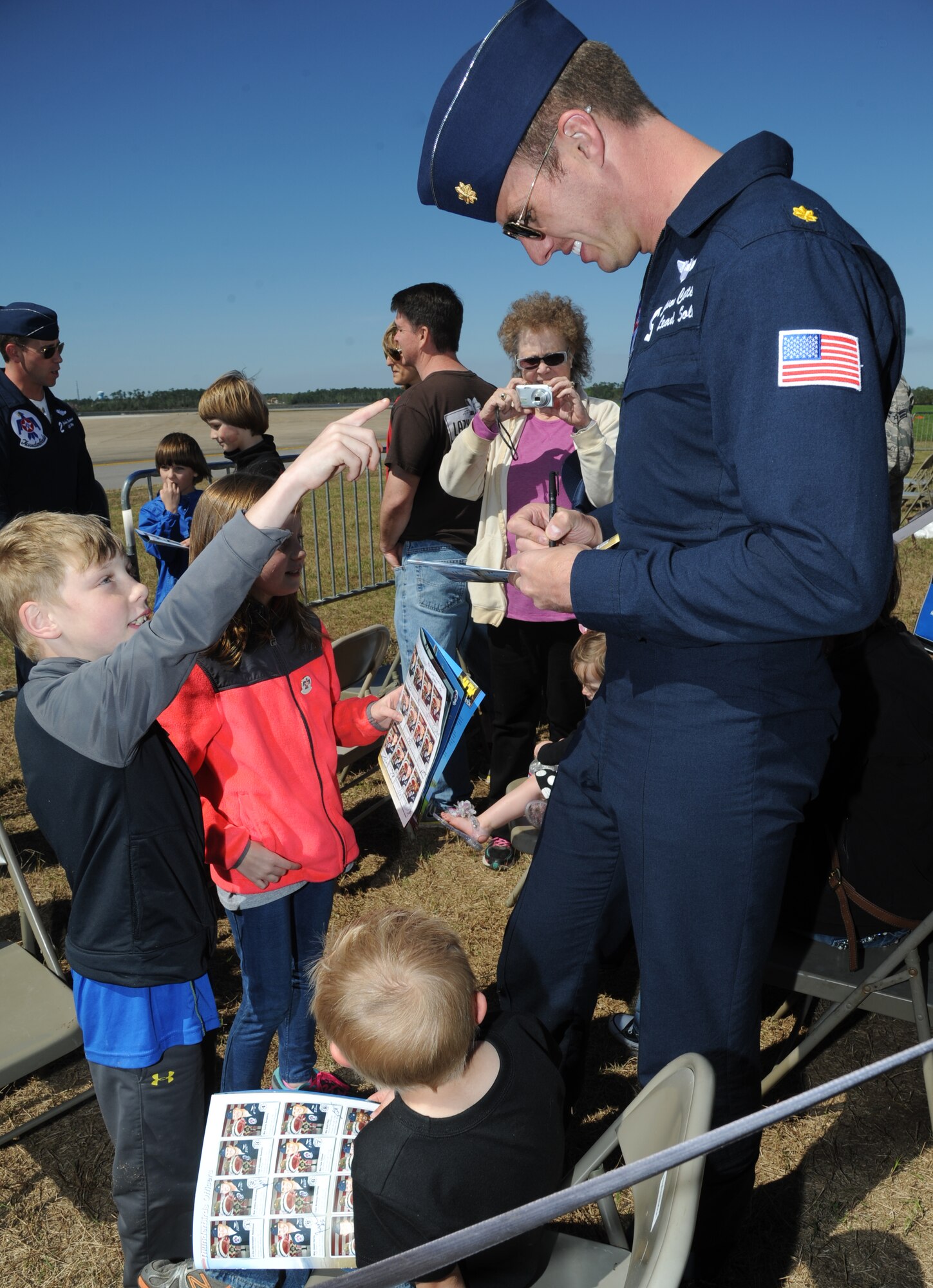 Maj. Jason Curtis, U.S. Air Force Thunderbird #5, autographs a Thunderbirds program for Waylon Walker during a Make-A-Wish Foundation meet-and-greet March 27, 2015, at Keesler Air Force Base, Miss. The Thunderbirds are headlining Keesler’s 2015 Air Show/Open House to be held March 28-29.  (U.S. Air Force photo by Kemberly Groue)