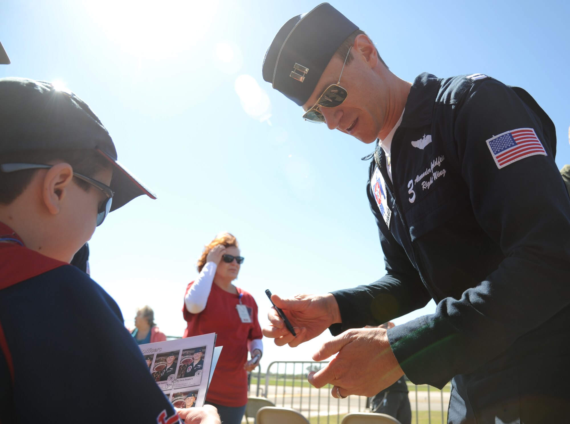 Capt. Alexander Goldfein, U.S. Air Force Thunderbird #3, autographs a Thunderbirds program for Dell Massy during a Make-A-Wish Foundation meet-and-greet March 27, 2015, at Keesler Air Force Base, Miss. The Thunderbirds are headlining Keesler’s 2015 Air Show/Open House to be held March 28-29.  (U.S. Air Force photo by Kemberly Groue)
