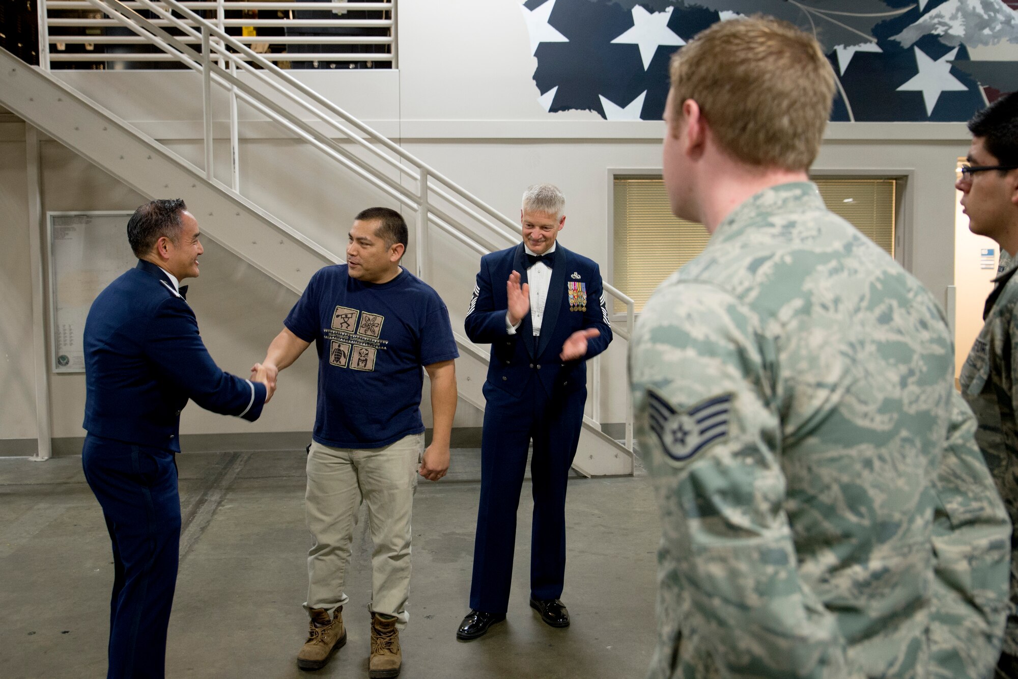Col. David Kumashiro (left), 62nd Airlift Wing commander, announces James San Agustin, 62nd Aerial Port Squadron aircraft freight loader and weapons safety officer, as the Air Mobility Command’s Civilian of the Year Category I, March 26, 2015, at Joint Base Lewis-McChord, Wash.  San Agustin over saw McChord Field’s $16 million all terrain forklift program to a 98 percent fully mission capable rate. (U.S. Air Force photo/Airman 1st Class Keoni Chavarria)
