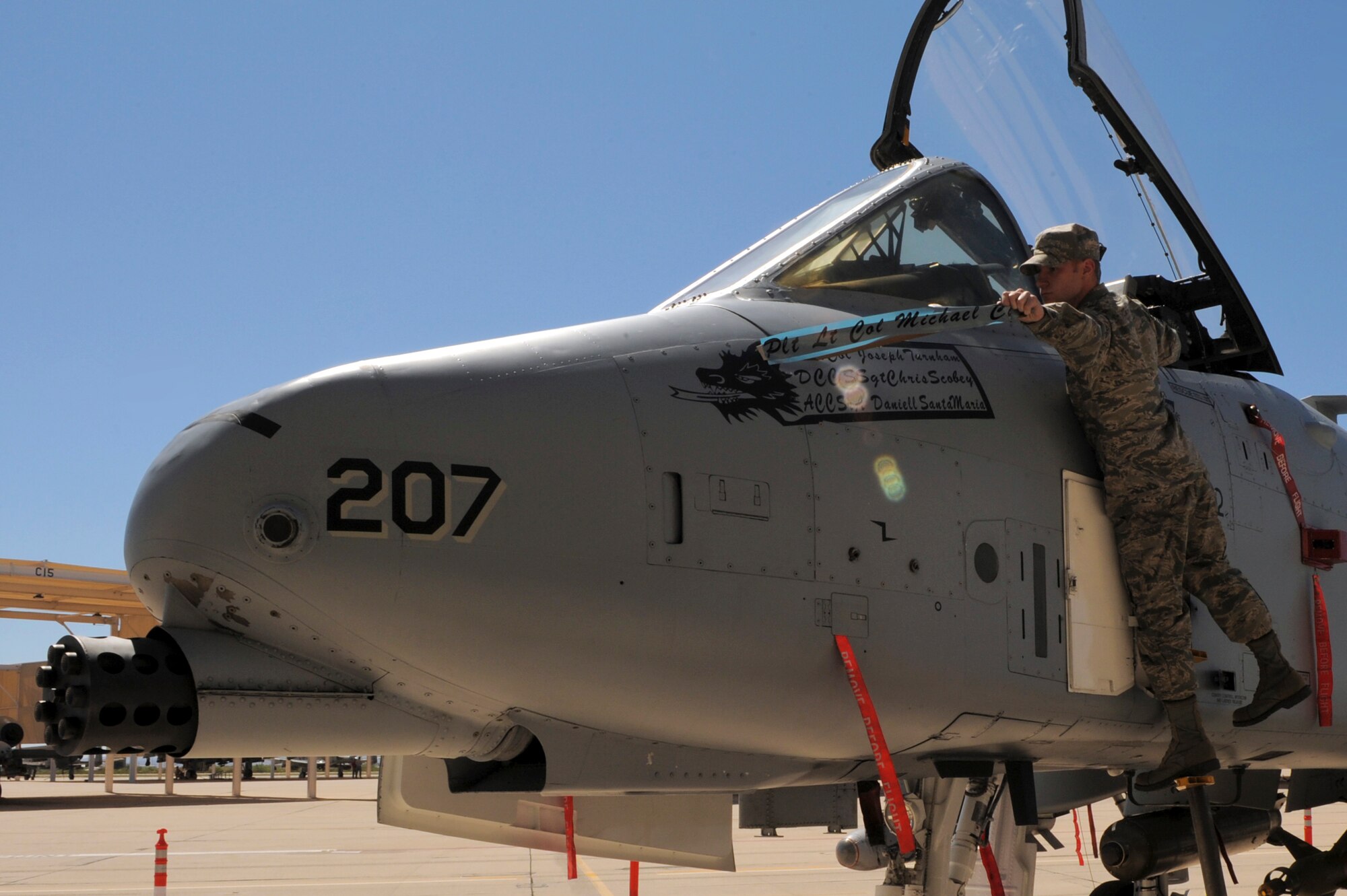 U.S. Air Force Staff Sgt. Christopher Scobey, 355th Aircraft Maintenance Squadron crew chief, removes the nametape of Lt. Col. Michael Curley, previous 357th Fighter Squadron commander, off of an A-10, to reveal the name of Lt. Col. Joseph Turnham, newly appointed 357th FS commander, during the 357th FS change of command ceremony at Davis-Monthan Air Force Base, Ariz., March 27, 2015. The nametape removal signified the relinquishment of command of the 357th FS from Curley to Turnham. (U.S. Air Force photo by Airman 1st Class Chris Drzazgowski/Released)