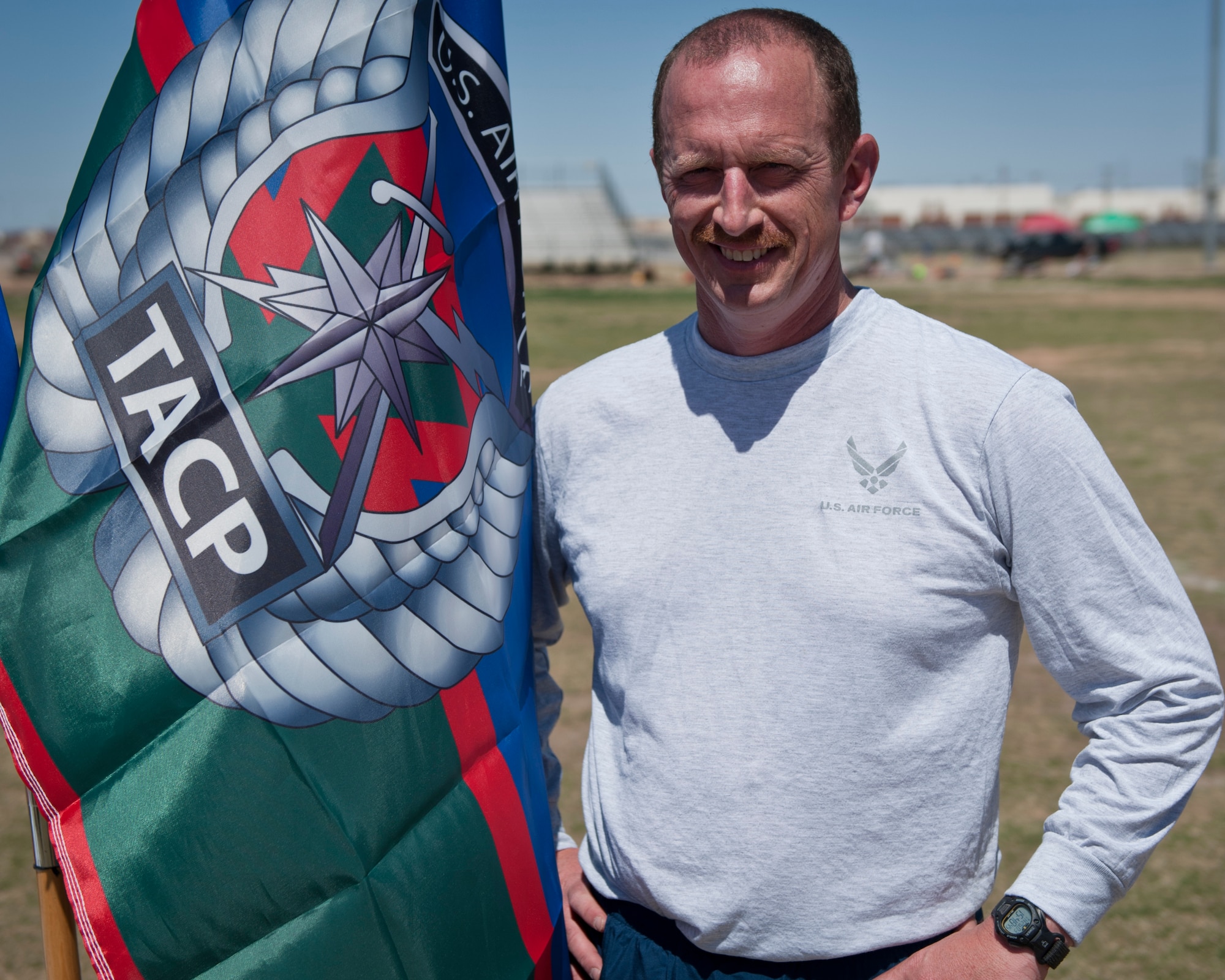 Lieutenant Colonel Steven A. Raspet, 7th Air Support Operations Squadron commander poses with the Tactical Air Control Party flag during the 24-hour Remembrance Run at Fort Bliss, Texas, March 26, 2015. Each year, TACP units from across the Air Force run for 24-hours in honor of TACP members who have made the ultimate sacrifice. Each unit raises money and collects donations that go toward the TACP foundation. (U.S. Air Force photo by Airman 1st Class Emily A. Kenney/Released)       