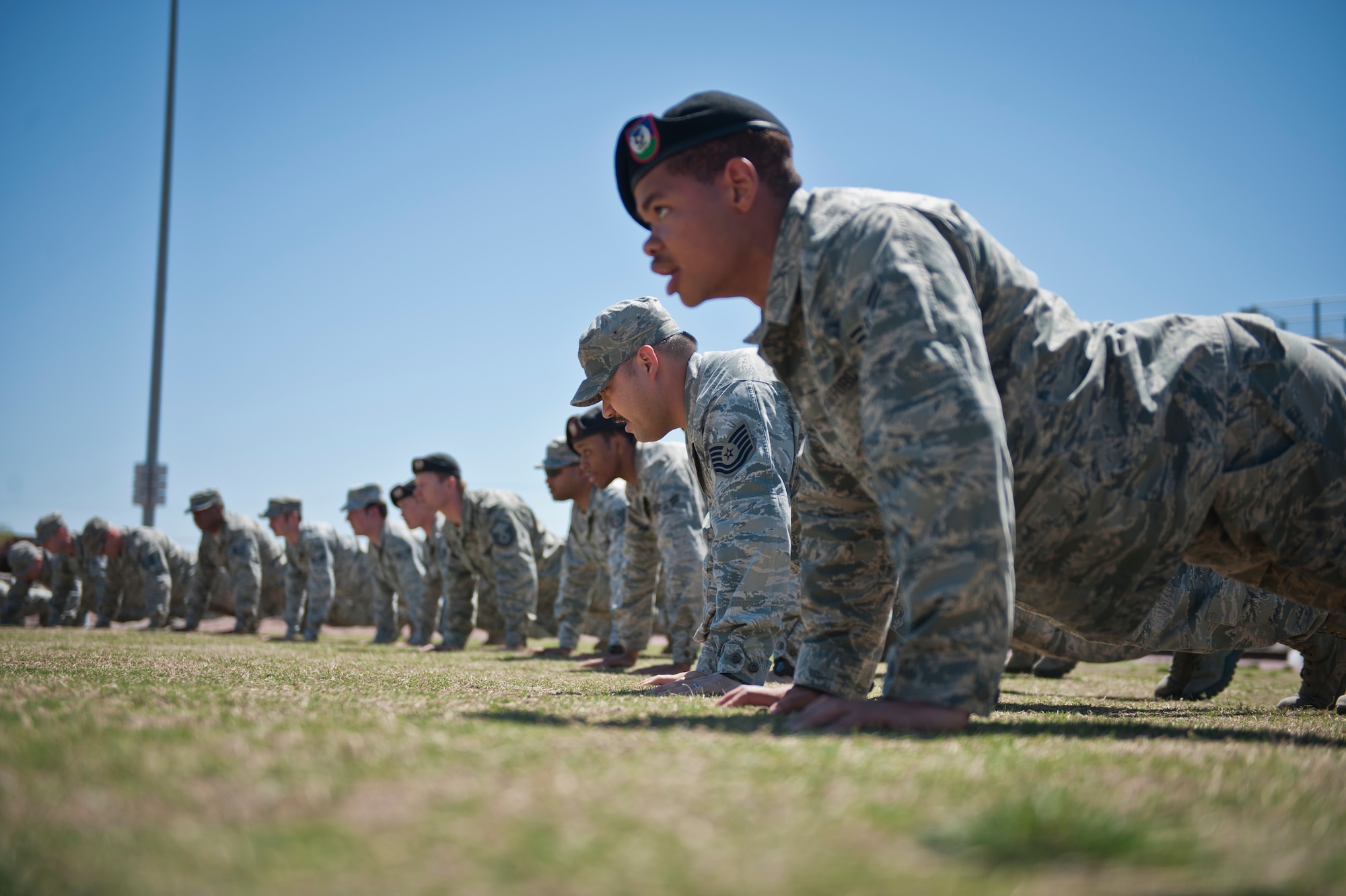 Airmen from the 7th Air Support Operations Squadron Tactical Air Control Party do memorial pushups before starting the 24-hour Remembrance Run at Fort Bliss, Texas, March 26, 2015. Each year, TACP units from across the Air Force run for 24-hours to honor the TACP members who have made the ultimate sacrifice. Each unit raises money and collects donations that go toward the TACP foundation. (U.S. Air Force photo by Airman 1st Class Emily A. Kenney/Released)