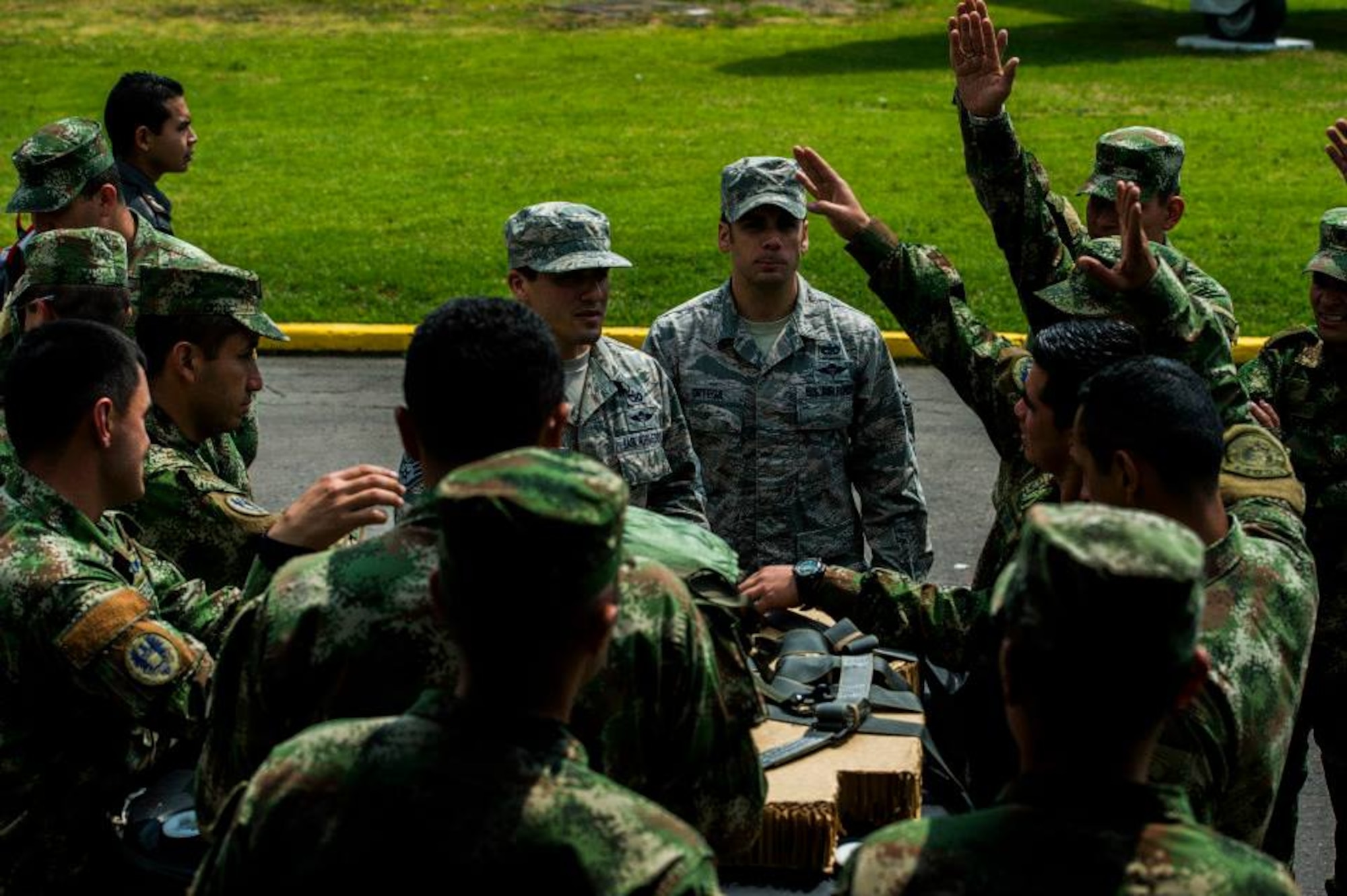 Staff Sgts. Peter Salinas and Angel Ortega, Rigger Air Advisors for the 571st Mobility Support Advisory Squadron, answer questions about pallet building in preparation for the first air drop with United States Air Force personnel aboard on March 2, 2015 at CATAM Air Force Base in Colombia, South America. (Photo by U.S. Air Force Tech. Sgt. Matthew Hannen)