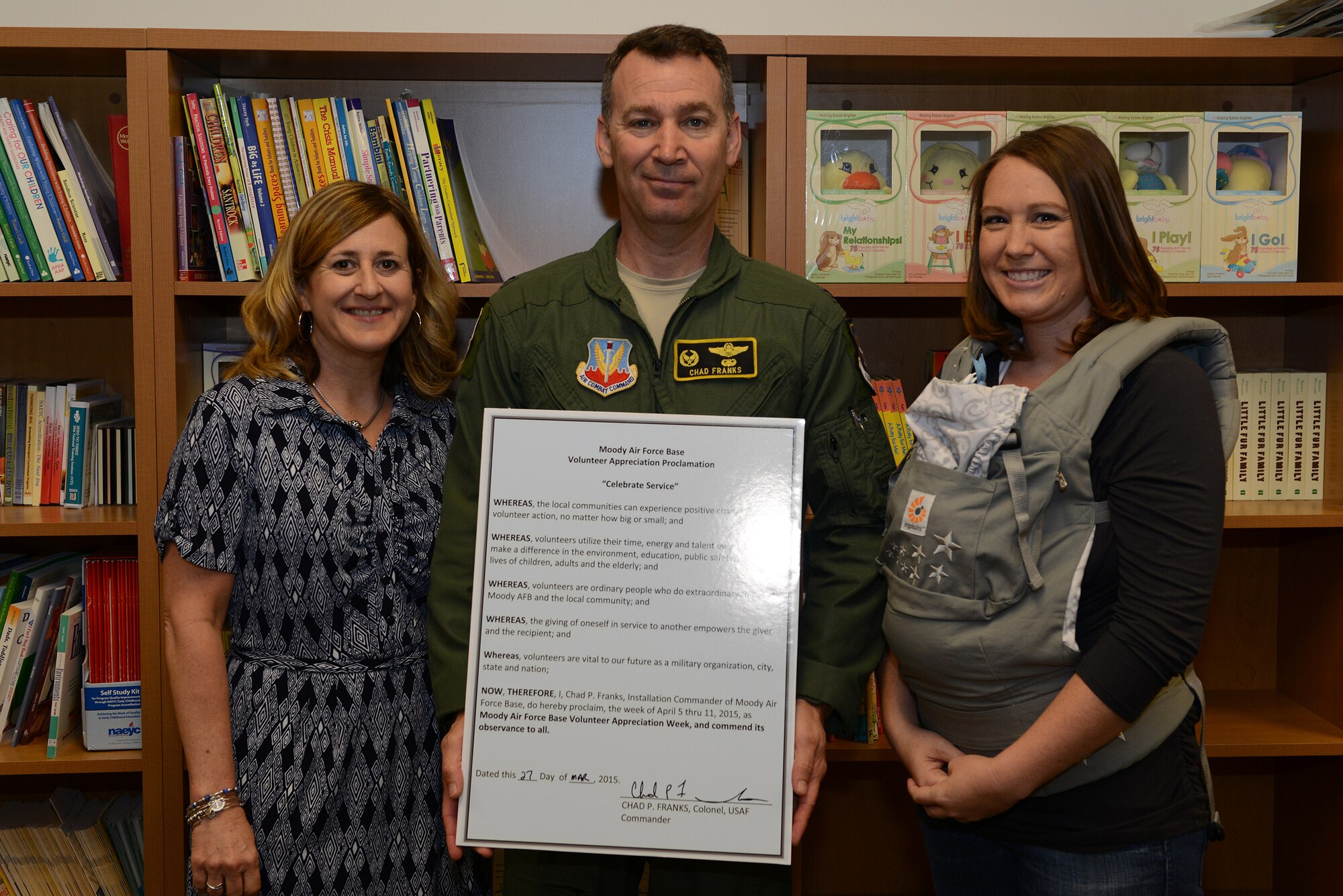 U.S. Air Force Col. Chad Franks, 23d Wing commander, and his wife Kim Franks, left, pose for a photo with Jessica Glover, Airman’s Attic volunteer, at the Volunteer Appreciation Proclamation signing March 27, 2015, at Moody Air Force Base, Ga. A Volunteer Recognition Ceremony will be held during Moody’s Volunteer Appreciation Week to acknowledge volunteers who put time into helping the base and local community. (U.S. Air Force photo by Airman 1st Class Kathleen D. Bryant/Released)