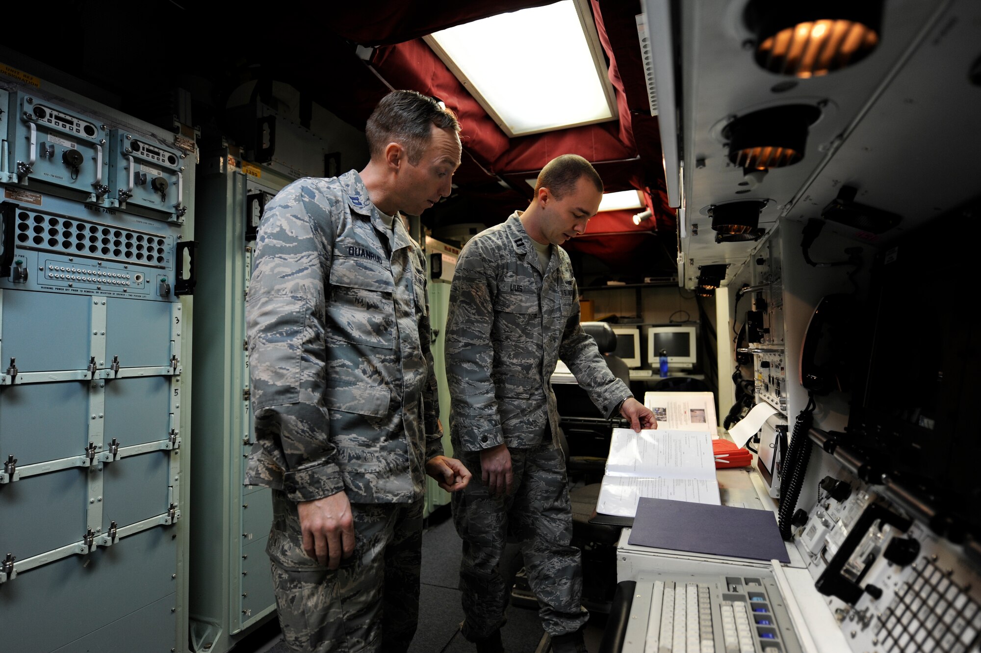 Capt. Andrew Quanrud, 576th Flight Test Squadron test operations officer, and Capt. Joseph Liles, 576th FLTS ICBM Field Test Management chief, review the procedures for installing a launch enable panel Feb. 26, 2015, during the Missile Alert Facility start-up for Glory Trip-214 and Glory Trip-215 at Vandenberg Air Force Base, California. The 576th plays a critical role in the operational test launch process, preparing facilities and equipment for the operational missile wings, which send missile crews to physically launch the unarmed Minuteman III missiles. (U.S. Air Force Photo by Airman 1st Class Ian Dudley)