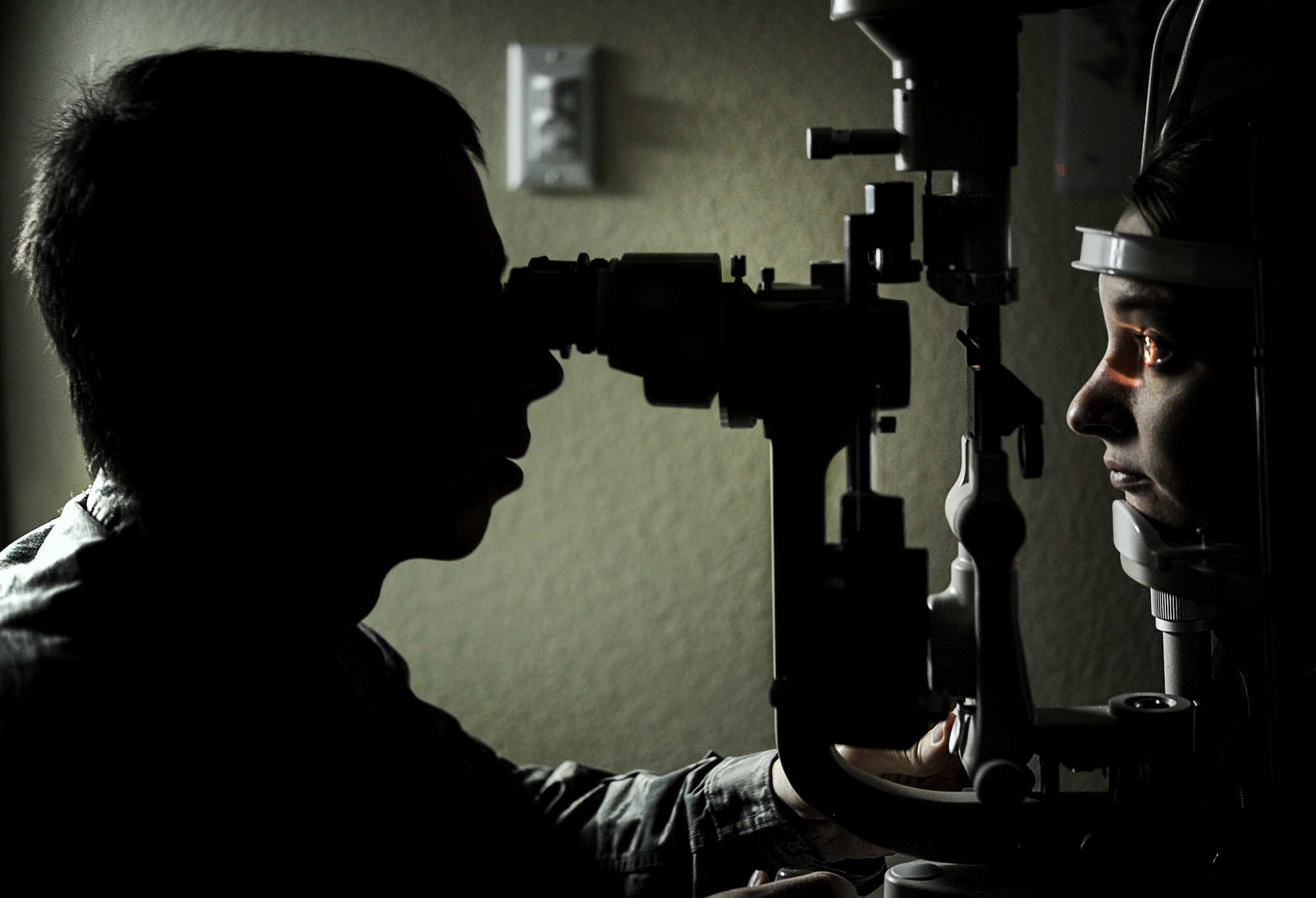 Capt. Makay Neilson, 5th Medical Operations Squadron optometrist, shines a light into Chelsea Hanson’s eye during an exam in the optometry clinic on Minot Air Force Base, N.D., March 23, 2015. Hanson’s eyes were dilated to allow the optometrist to view the inside of her eye. (U.S. Air Force photo/Senior Airman Stephanie Morris)
