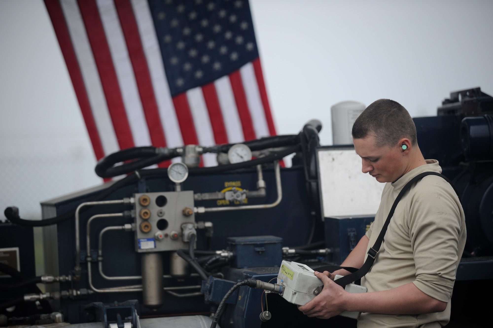 Airman 1st Class Riley Mausbach, 90th Missile Maintenance Squadron missile handling technician, operates the remote control to raise the transporter-erector tower into place above Launch Facility-10 Feb. 20, 2015, during the missile emplacement process for Glory Trip-214, Vandenberg Air Force Base, California. Airmen from F.E. Warren, Malmstrom and Vandenberg Air Force Bases worked in tandem to prepare the launch facilities for two Minuteman III operational test launches, the last week of March. (U.S. Air Force photo by Airman 1st Class Ian Dudley)