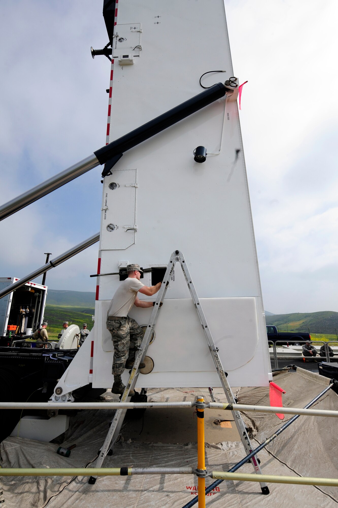 Staff Sgt. Joshua Kerschner, 576th Flight Test Squadron missile handling technician, inspects the securing strap around the transporter-erector tower Feb. 20, 2015 before the Minuteman III booster is lowered into place at Launch Facility-10 for Glory Trip-214, at Vandenberg Air Force Base, California. The unarmed missile was later launched to a test range over 6,000 miles away in the Pacific Ocean near the island of Guam, making it the longest recorded Minuteman III launch ever. (U.S. Air Force photo by Michael Peterson)