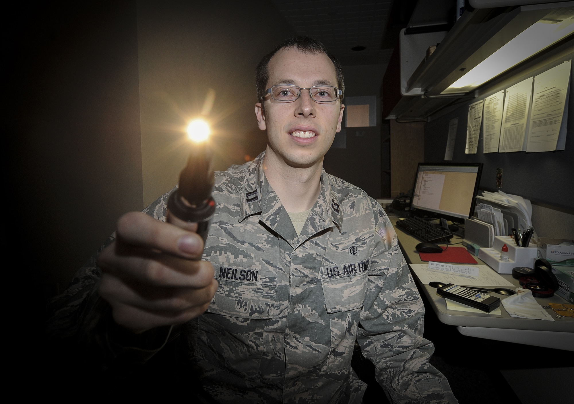 Capt. Makay Neilson, 5th Medical Operations Squadron optometrist, poses for a photograph in the optometry clinic on Minot Air Force Base, N.D., March 23, 2015. Neilson examines both active duty Airmen and their dependents, as well as members of the personnel reliability program. (U.S. Air Force photo/Senior Airman Stephanie Morris)