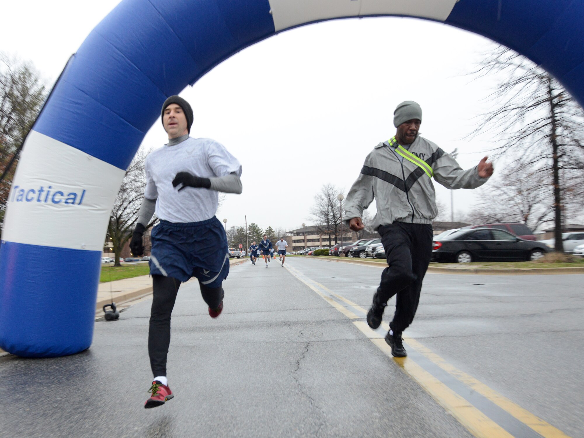An Air National Guard Readiness Center Airman and an Army Readiness Center Soldier finish strong at the ANGRC fun run held at Joint Base Andrews, Md., March 27, 2015. (U.S. Air National Guard photo by Senior Airman John E. Hillier/Released)