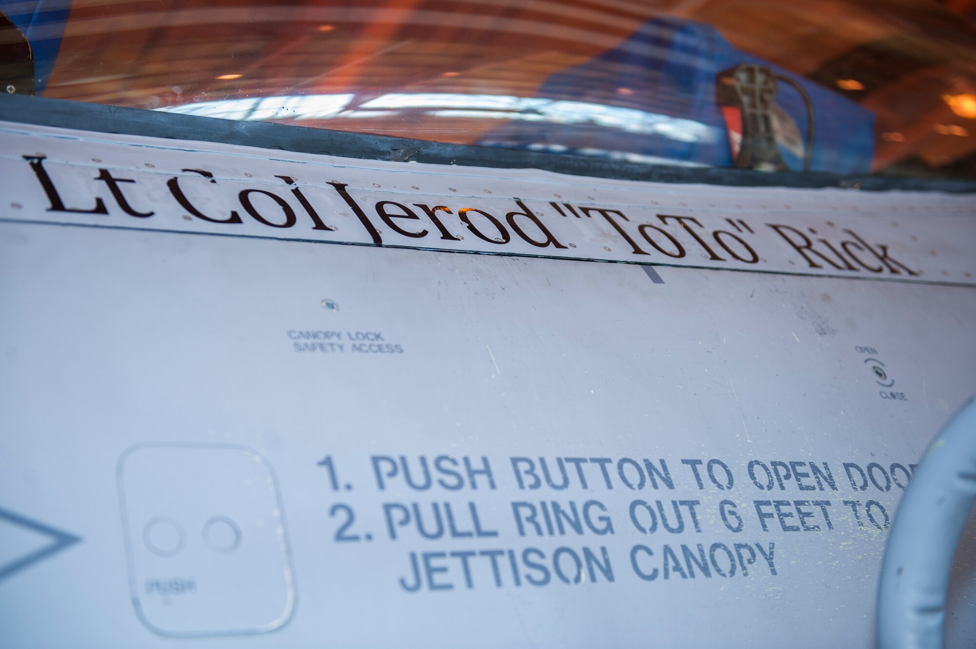 Lieutenant Colonel Jerod Rick, 54th Operations Support Squadron incoming commander, has his name unveiled on an F-16 Falcon during the 54th OSS change of command at Holloman Air Force Base, N.M., March 27, 2015. In the ceremony, Lt. Col. Jerod Rick assumed command of the 54th OSS from Lt. Col. Marshall Chalverus. The 54th OSS is a fighter training unit that trains 45 percent of all F-16 Falcon student pilots. They also manage Intelligence, Air Crew Flight Equipment, and Simulator and Training Devices. (U.S. Air Force photo by Airman 1st Class Emily Kenney / Released)