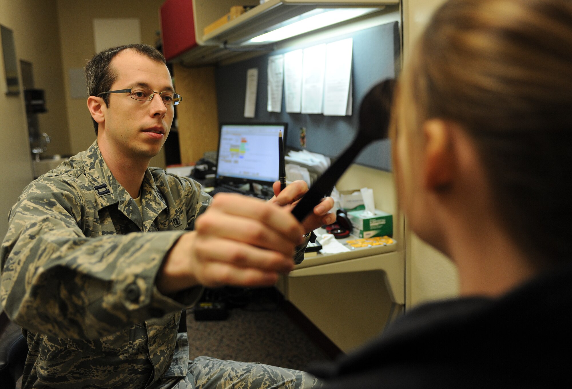 Capt. Makay Neilson, 5th Medical Operations Squadron optometrist, uses a paddle to cover one of Chelsea Hanson’s eyes in the optometry clinic on Minot Air Force Base, N.D., March 23, 2015. Neilson used the paddle to perform tests on one eye at a time and accurately judge if either had any vision problems. (U.S. Air Force photo/Senior Airman Stephanie Morris)