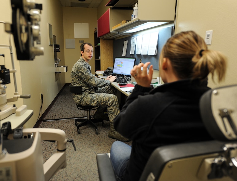 Capt. Makay Neilson, 5th Medical Operations Squadron optometrist, talks to Chelsea Hanson about her vision in the optometry clinic on Minot Air Force Base, N.D., March 23, 2015. Hanson came to the clinic for a routine check-up and to test her low light vision. (U.S. Air Force photo/Senior Airman Stephanie Morris)
