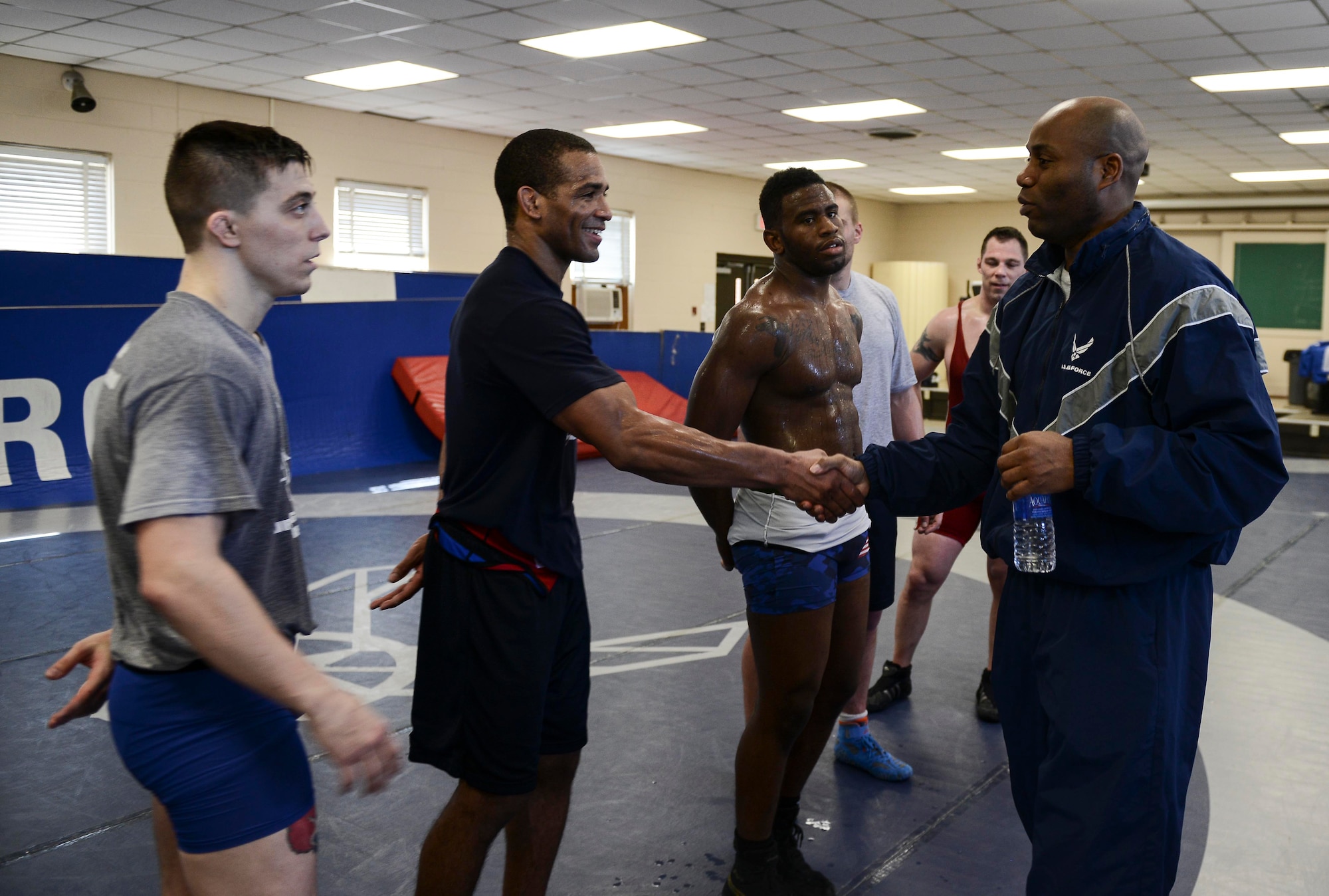Members of the U.S. Air Force Wrestling Team meet with Lt. Col. Todd Randolph, 87th Force Support Squadron commander, after practice on Joint Base McGuire-Dix-Lakehurst, N.J. March 17, 2015. The team is currently competing in the Armed Forces Championships at Fort Carson, Colo. (U.S. Air Force photo by Joshua King/Released)