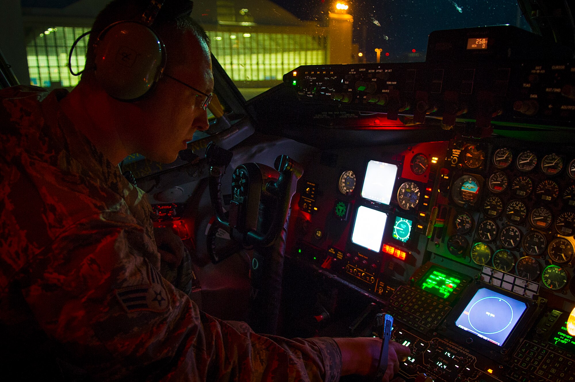Senior Airman Joshua Dobrowski, 6th Aircraft Maintenance Squadron crew chief, checks KC-135 Stratotanker internal cockpit lights and nose landing lights during a preflight inspection at MacDill Air Force Base, Fla., March 26, 2015. The landing gears, electronics systems and the structure of airframe are checked during each preflight inspection. (U.S. Air Force photo by Senior Airman Ned T. Johnston/Released)