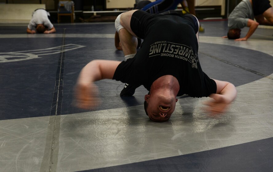 Airman Tyler Westlund, 88th Force Support Squadron, stretches during wrestling practice on Joint Base-McGuire-Dix-Lakehurst, N.J. March 12, 2015. Westlund is a member of the U.S.  Air Force Wrestling Team and is a former high school state and national champion. (U.S. Air Force photo by Airman 1st Class Joshua King/Released)