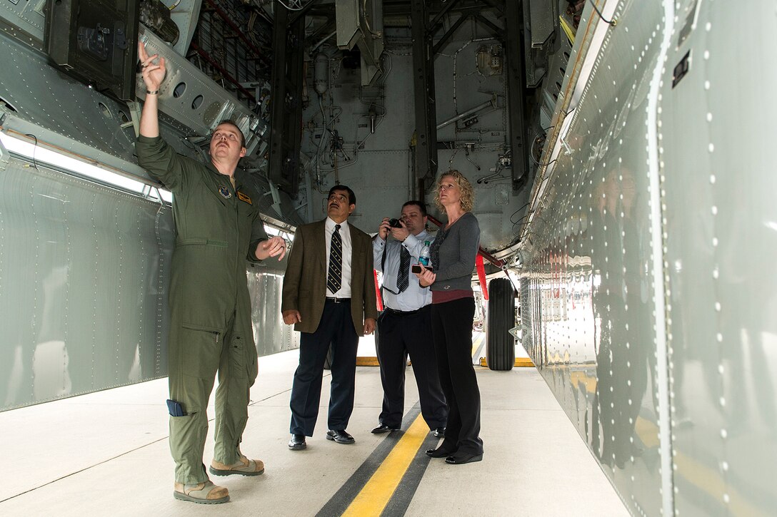 U.S. Air Force Major Courtney Hancock, assigned to the 11th Bomb Squadron, points out features in the bomb bay of a B-52 Stratofortress on Barksdale Air Force Base, La. March 19, 2015. Major Hancock gave a tour of the plane to members of the Fort Worth Airpower Foundation while they were visiting the 307th Bomb Wing. (U.S. Air Force Photo by Master Sgt. Greg Steele/Released)