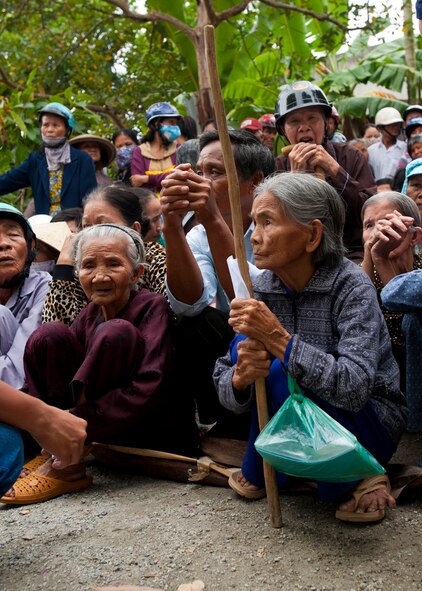 Local residents await the arrival of U.S. and multinational military medical professionals at Duc Pho vocational training school, Quang Ngai Province, Vietnam, March 27, 2015. The school was turned into a temporary medical care site for Operation Pacific Angel 15-3. PACANGEL is a total force, joint and combined humanitarian assistance operation led by the U.S. Pacific Air Forces. The operation promotes interoperability amongst U.S. military, host nation and multilateral military and civilian organizations. (U.S. Air Force photo by Staff Sgt. Tong Duong/ Released)