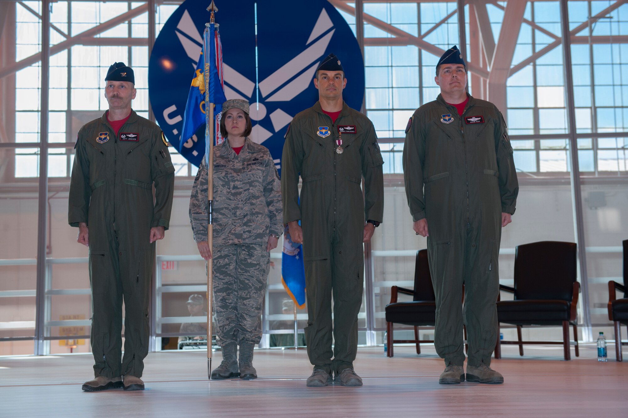 Colonel Jeff Jensen, 54th Fighter Group commander, Lt. Col. Marshall Chalverus, 54th Operations Support Squadron outgoing commander and Lt. Col. Jerod Rick, 54th OSS incoming commander, prepare to receive orders to formally change command during the 54th OSS change of command at Holloman Air Force Base, N.M., March 27, 2015. In the ceremony, Lt. Col. Jerod Rick assumed command of the 54th OSS from Lt. Col. Marshall Chalverus. The 54th OSS is a fighter training unit that trains 45 percent of all F-16 Falcon student pilots. They also manage Intelligence, Air Crew Flight Equipment, and Simulator and Training Devices. (U.S. Air Force photo by Airman 1st Class Emily Kenney / Released)