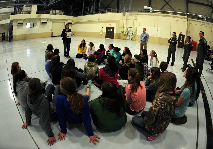 Diane Hahn, North Dakota State University extension 4H military programs manager, speaks to the girls attending the base science, technology, engineering and math program about what the 69th Reconnaissance Group does on a daily basis Mar. 25, 2015 on Grand Forks Air Force Base, N.D. The children later learned how to fly mini remotely piloted aircraft with help from base pilots in a hangar before continuing on to their next stop during the tour. (U.S. Air Force Photo/Senior Airman Zachiah Roberson)
