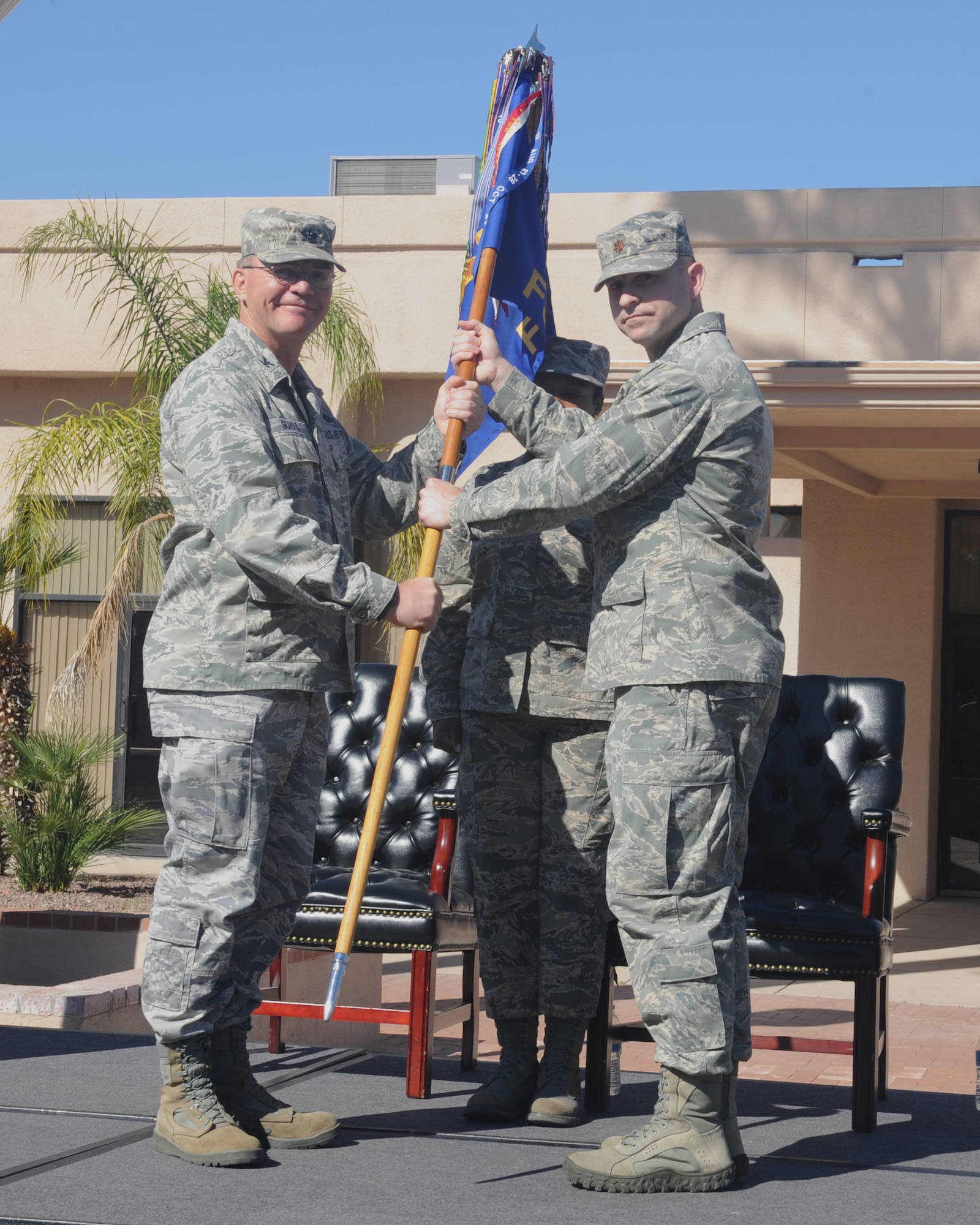 U.S. Air Force Maj. Stephen Anderson receives the 355th Force Support Squadron guidon from Col. Rodger Schuld, 355th Mission Support Group commander, during the 355th FSS change of command ceremony at Davis-Monthan Air Force Base Ariz., March 27, 2015. Anderson assumed command over the men and women of the 355th FSS. (U.S. Air Force photo by Airman 1st Class Cheyenne Morigeau/Released) 