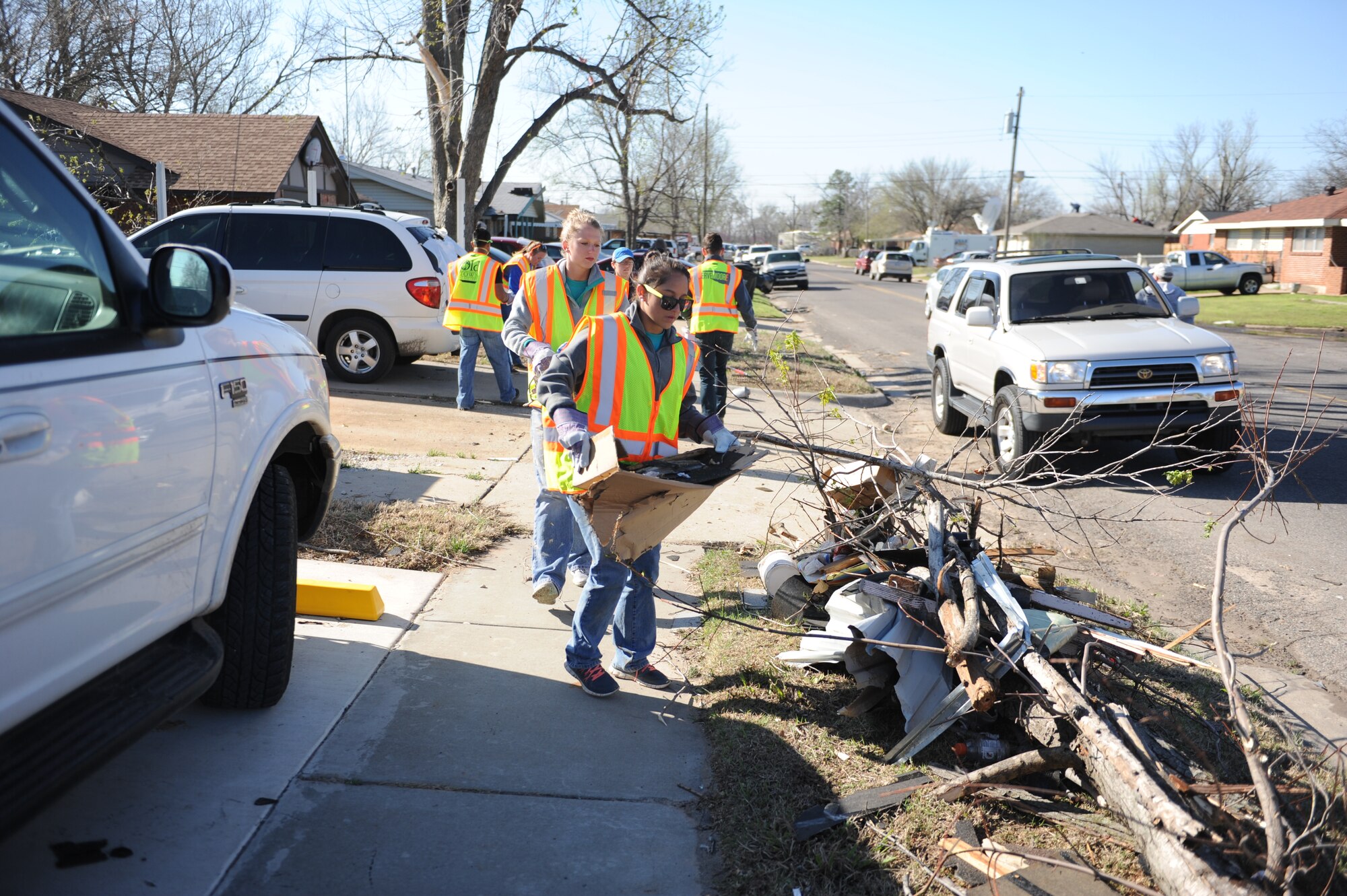 U.S. Air Force Academy cadets collect debris from the streets of Moore, Okla., March 26, 2015. A late-afternoon tornado struck the small community, just outside Oklahoma City, March 25, 2015. Fifteen cadets were in Moore March 23-27 to build homes with Habitat for Humanity as part of their Alternative Spring Break Program. (U.S. Air Force photo/John Van Winkle)