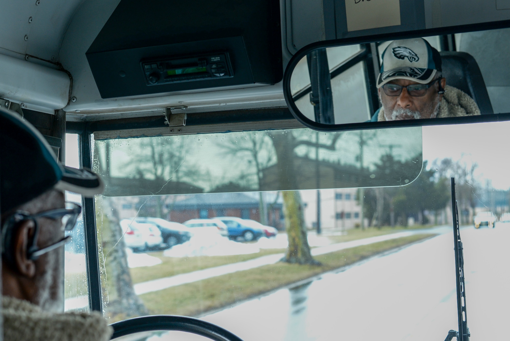 Charles Bogan, shuttle bus driver on Joint Base McGuire-Dix-Lakehurst, N.J., drives the route through the McGuire-Dix area March 26, 2015. The shuttle service, which most people might recognize as the white bus that typically drives around, transporting service members throughout the joint base, will no longer be available as of March 31, 2015. (U.S. Air Force photo by Airman 1st Class Tara A. Williamson/Released)