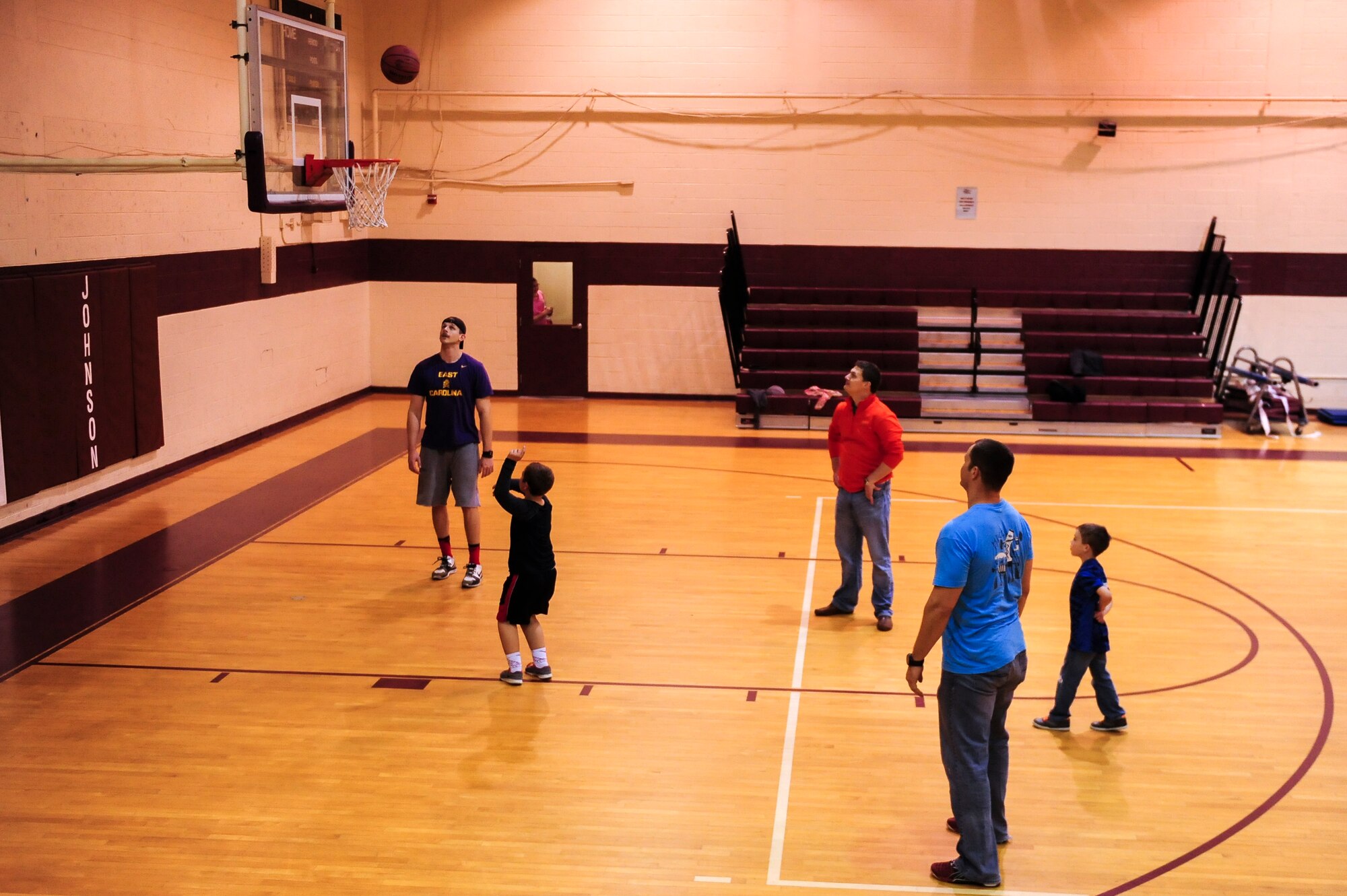 Members of a fighter squadron play basketball with children during a “Mom’s Day Out” event, March 14, 2015, at Seymour Johnson Air Force Base, North Carolina. The squadron set up multiple activities to give children of deployed service members the chance to interact with role models. (U.S. Air Force photo/Senior Airman Brittain Crolley)