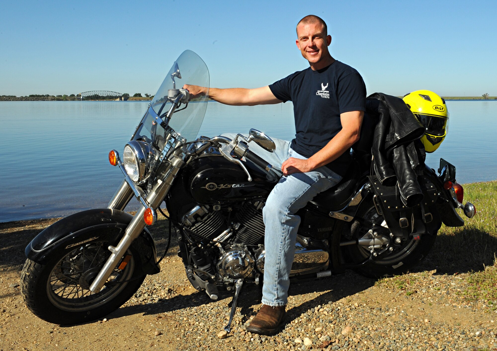 Chaplain (Capt.) R. Brenner Campbell, 9th Reconnaissance Wing chaplain, poses with his motorcycle at Camp Far West Lake in Wheatland, Calif., March 27, 2015. (U.S. Air Force photo by Airman 1st Class Ramon A. Adelan/Released)