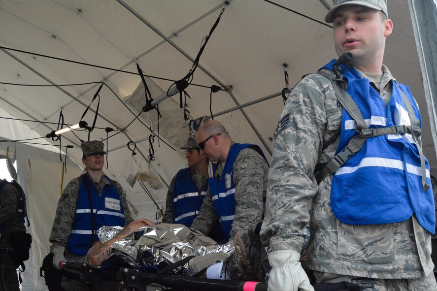 U.S. Airmen assigned to the Missouri National Guard’s Homeland Response Force Medical Element treat a mock patient March 20, 2015 at Camp Gruber in Braggs, Okla. The guardsmen were evaluated on their ability to respond to a large scale natural disaster or terrorist attack. (U.S. Air National Guard photo by Airman 1st Class Chayla Hurd/Released)