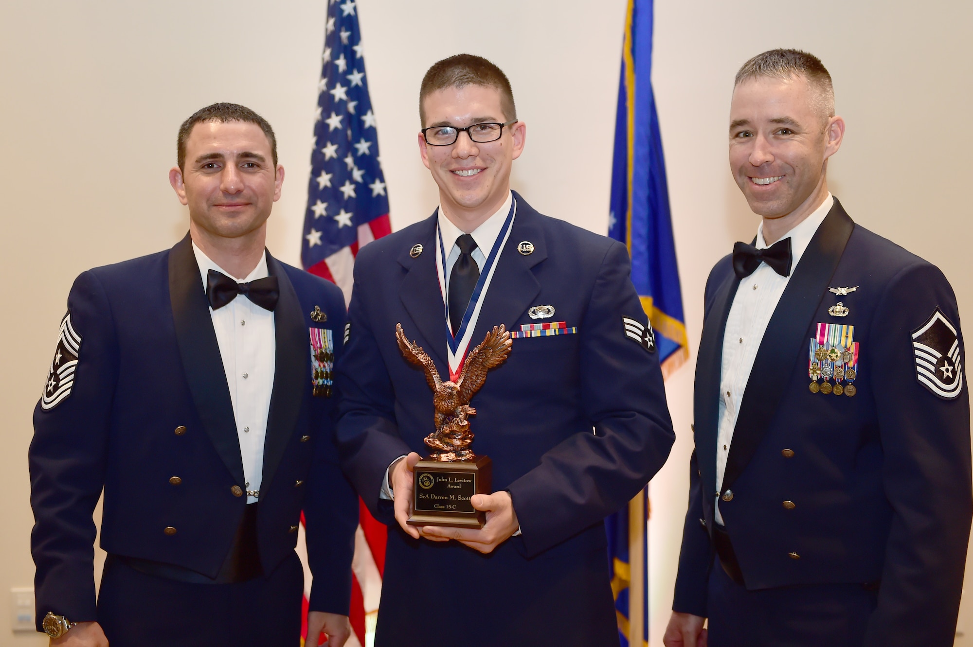 Senior Airman Darren Scott, 460th Space Wing Public Affairs broadcaster, receives the John L. Levitow Award during the Buckley Airman Leadership School Class 15-C graduation March 26, 2015, at the Leadership Development Center on Buckley Air Force Base, Colo. The Levitow award is given to the ALS graduate with the highest academic scores and leadership potential. (U.S. Air Force photo by Airman 1st Luke Nowakowski /Released)