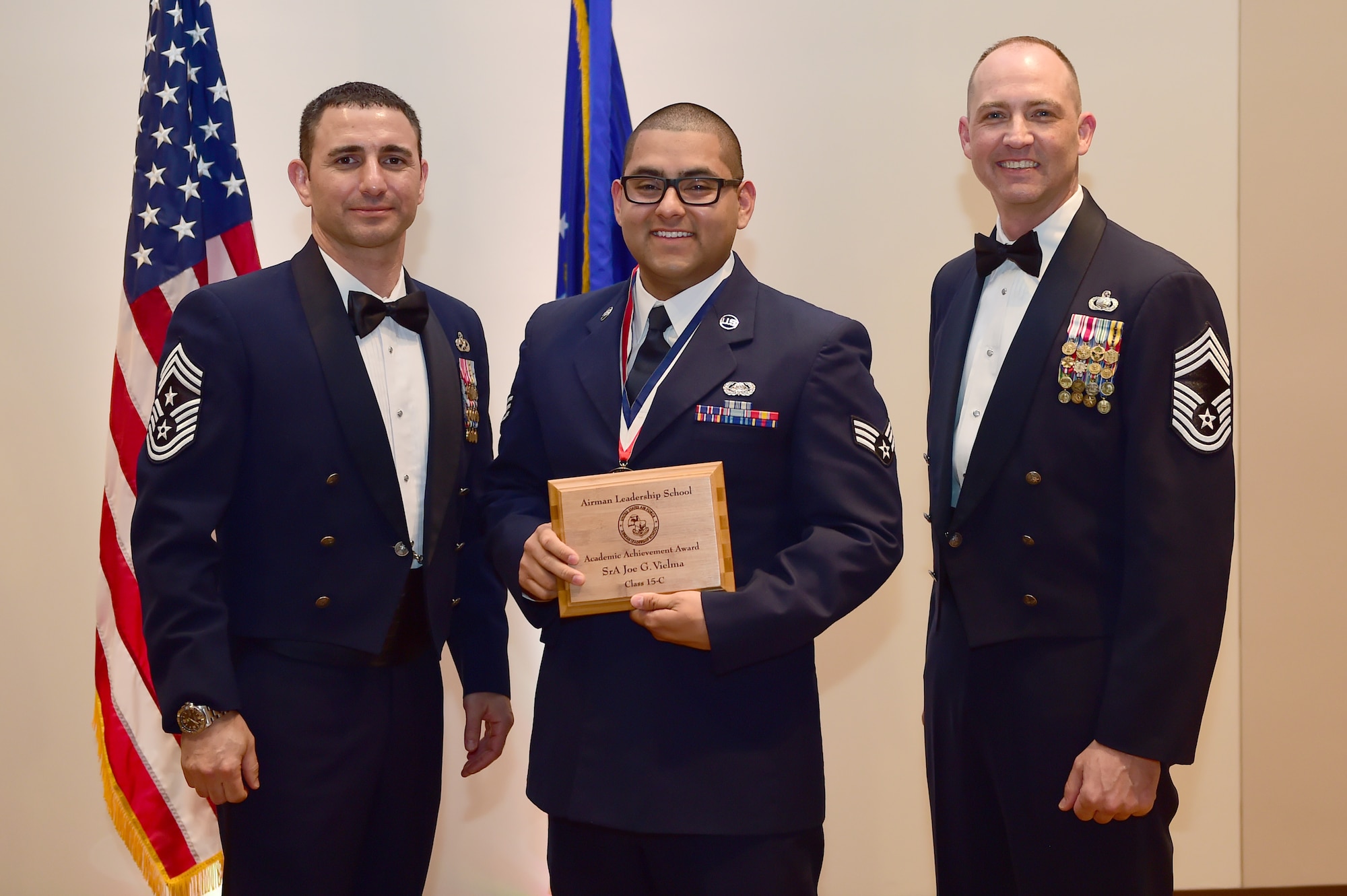 Senior Airman Joe G. Vielma, Aero Space Data Facility - Colorado, receives the Academic Achievement Award during the Buckley Airman Leadership School Class 15-C graduation March 26, 2015, at the Leadership Development Center on Buckley Air Force Base, Colo. This award is presented to the student with the highest overall average on all academic evaluations during ALS. (U.S. Air Force photo by Airman 1st Class Luke Nowakowski/Released)
