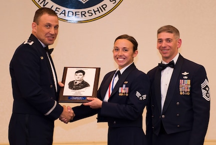 Senior Airman Samantha Varden from the 437th Airlift Wing receives the John L. Levitow Award from Col. Johnny Lamontagne, 437th AW commander, and Chief Master Sgt. Shawn Hughes, 437th AW command chief March 26, 2015, at the Charleston Club on Joint Base Charleston, S.C. Varden received the highest award in her graduation class because she demonstrated the traits of a true leader. (U.S. Air Force photo/Airman 1st Class Clayton Cupit)