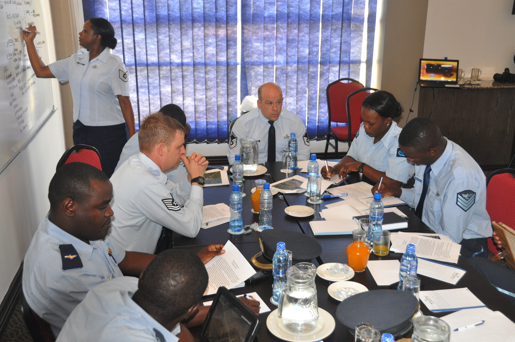 Joint Base McGuire-Dix-Lakehurst, N.J. -- U.S. Air Force Tech Sgt. Tennille Preston, 621st Contingency Response Wing, 818th Mobility Support Advisory Squadron, presents a table top exercise to members of the Zambian Air Force. Her team traveled to Lusaka, Zambia to take part in a first of its kind Department of State training event under the new section 1203 authority, March 21, 2015. The team engaged with twenty members of the Zambian air force to share ideas while completing upgrade training. (Courtesy Photo provided by 818th Mobility Support Advisory Squadron).
