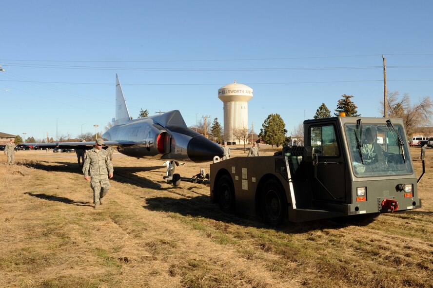 Ellsworth Airmen help transport an F-102 Delta Dagger from the flightline to the South Dakota Air and Space Museum at Ellsworth Air Force Base, S.D., March 13, 2015. The Bomb Wing has had the F-102 since 1987 in the museum’s restoration facility, Dock 43, and will unveil the interceptor this fall. (U.S. Air Force photo by Senior Airman Hailey R. Staker/Released)