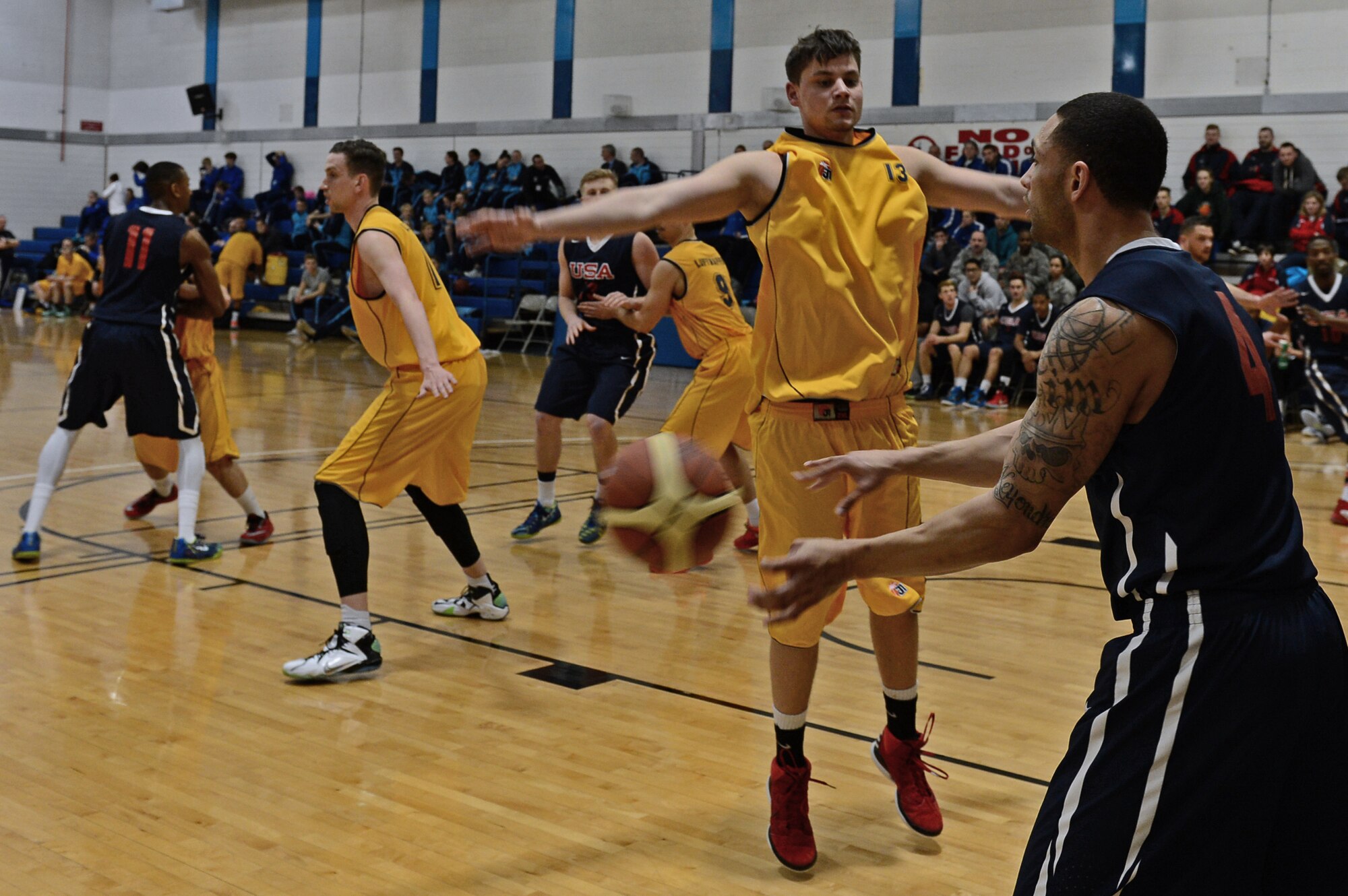 Timothy White, U.S. Air Force men’s basketball player, passes the ball to a teammate during NATO’s Inter-Nation Sports Championship men’s final against Germany at Royal Air Force Lakenheath, England, March 26, 2015. The U.S. Air Force hosted this year’s event, including air forces from Belgium, Poland, the Netherlands, Germany and the U.K. (U.S. Air Force photo by Airman 1st Class Erin R. Babis/Released)