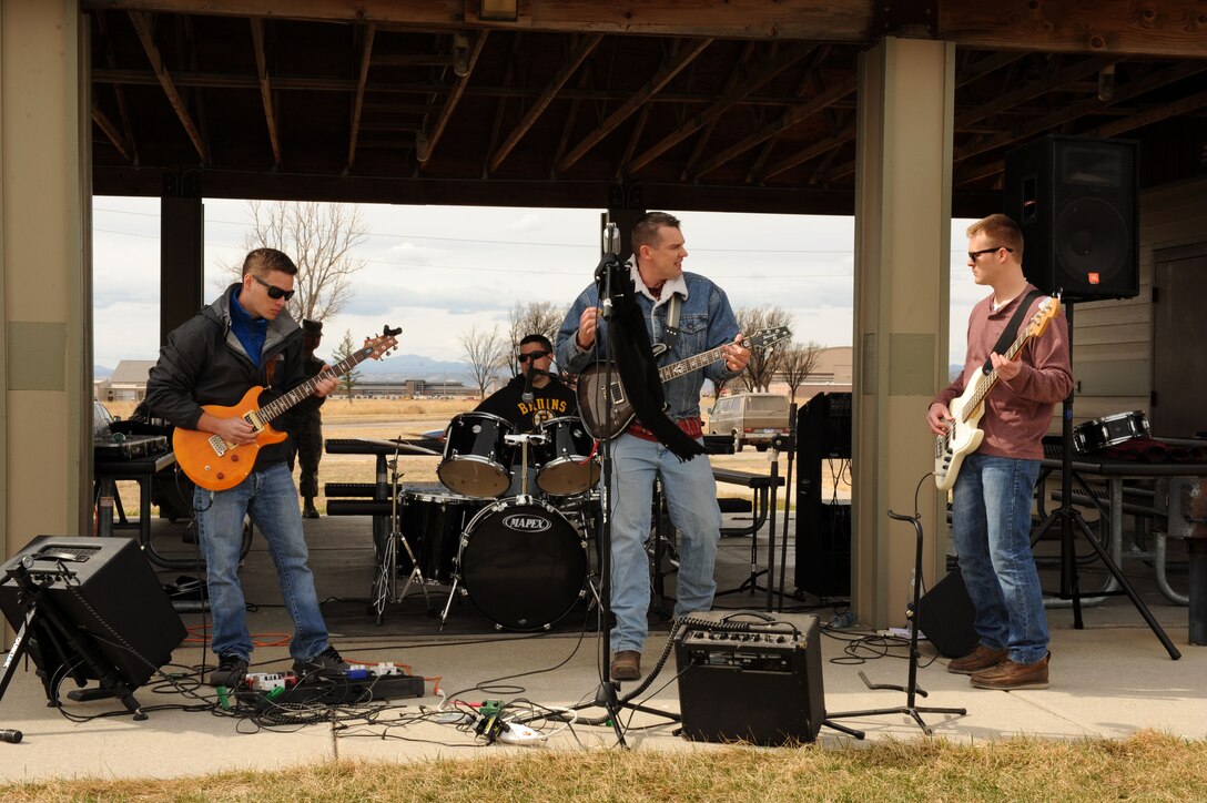 The Randoms, a band whose members are air traffic controllers from the 28th Operations Support Squadron, provide live music at the Air Force Assistance Fund campaign kick-off paintball tournament outside the Bellamy Fitness Center at Ellsworth Air Force Base, S.D., March 23, 2015. The campaign committee organized the event with Outdoor Recreation and provided lunch for participants. (U.S. Air Force photo by Senior Airman Hailey R. Staker/Released)