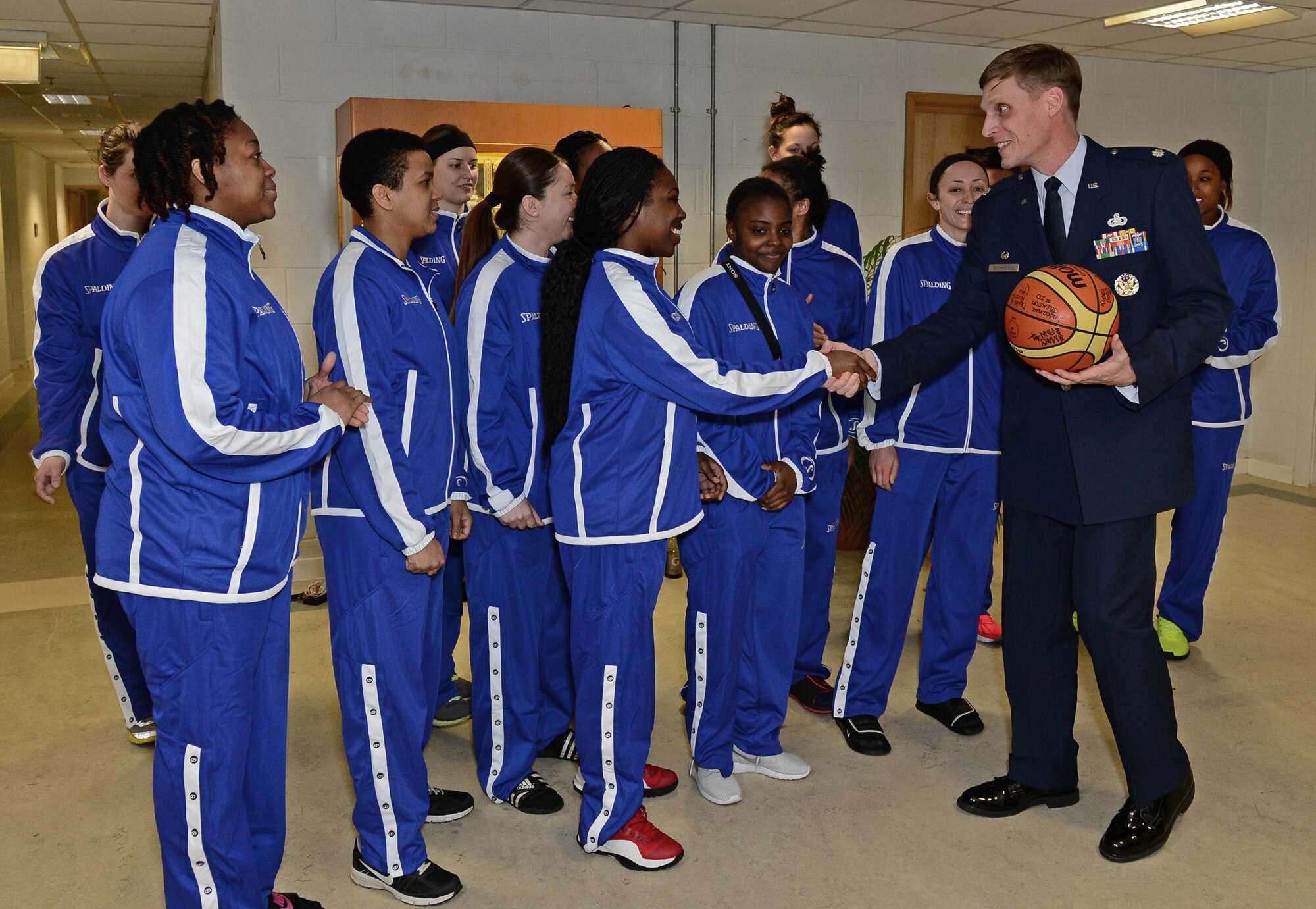 The U.S. Air Force women’s basketball team presents the game ball to Lt. Col. Ryan Richardson, 48th Force Support Squadron commander, at Royal Air Force Lakenheath, England, March 26, 2015. The team thanked Richardson for hosting them at NATO’s Inter-Nation Sports Championship. (U.S. Air Force photo by Airman 1st Class Erin R. Babis/Released)