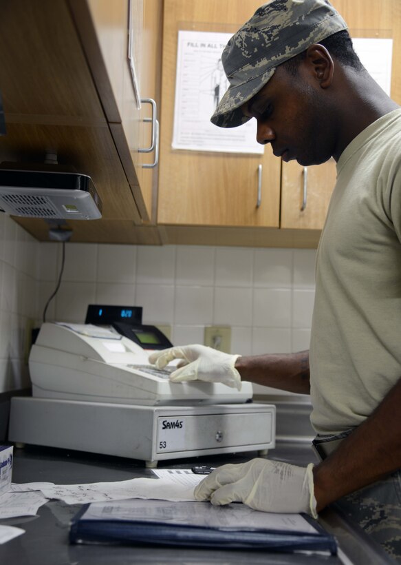 Staff Sgt. Terell Ballard, 341st Force Support Squadron senior missile chef, calculates the costs of meals March 16 at a missile alert facility near Malmstrom Air Force Base, Mont. Ballard takes orders before each meal and must collect and secure payment for them until he can return to base. (U.S. Air Force photo/Airman 1st Class Dillon Johnston)