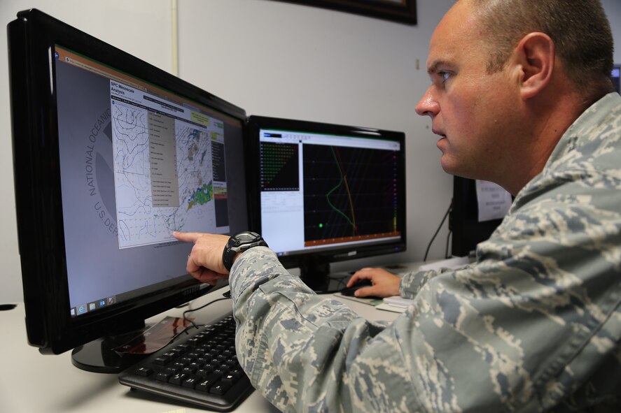 Maj. Chris Higgins, 12th Operational Weather Flight, 932nd Airlift Wing, looks at information from the Storm Prediction Center with his main focus being convective activity and severe thunderstorms.  The Air Force has always been the backup agency for the Storm Prediction Center (SPC).  It was on May 1, 2009 that the mission came to the 15th Operational Weather Squadron.   The SPC handed off support to Airmen like Maj. Higgins on 26 March and even though SPC has a lot of other weather speciality products they produce, the ones that 12 OWF are in charge of are the convective outlooks days and weather watches.   SPC is located in Norman, Oklahoma, so if they ever have to shelter for a tornado the Storm Prediction Center backup team is called in to take over.  Maj. Higgins spent time on the phones with weather managers in various states during the event.  (U.S. Air Force photo/Maj. Stan Paregien)