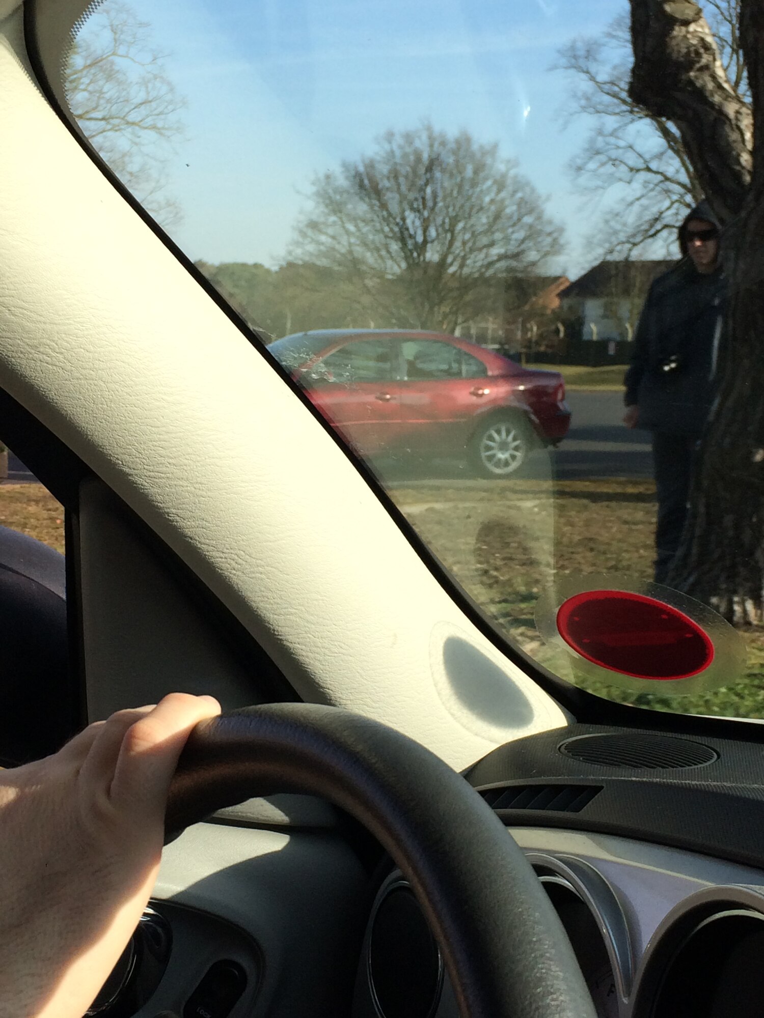 Senior Airman Trenton Hawk, 48th Civil Engineer Squadron, watches as a concerned Liberty Wing family member takes a photo of his suspicious behavior at Royal Air Force Lakenheath, England, March 12, 2015. This photo was submitted to the 48th Security Forces Squadron to alert them of the suspicious activity taking place outside Gate2 during a base Eagle Eyes exercise. (Courtesy photo/Released)